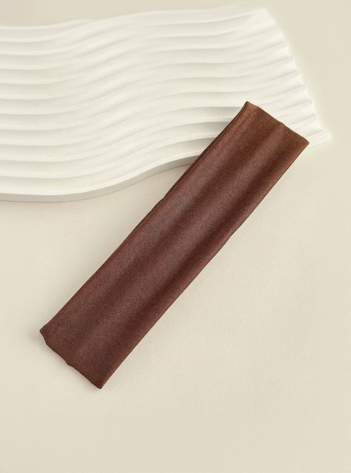 Brown fabric strip on a beige background