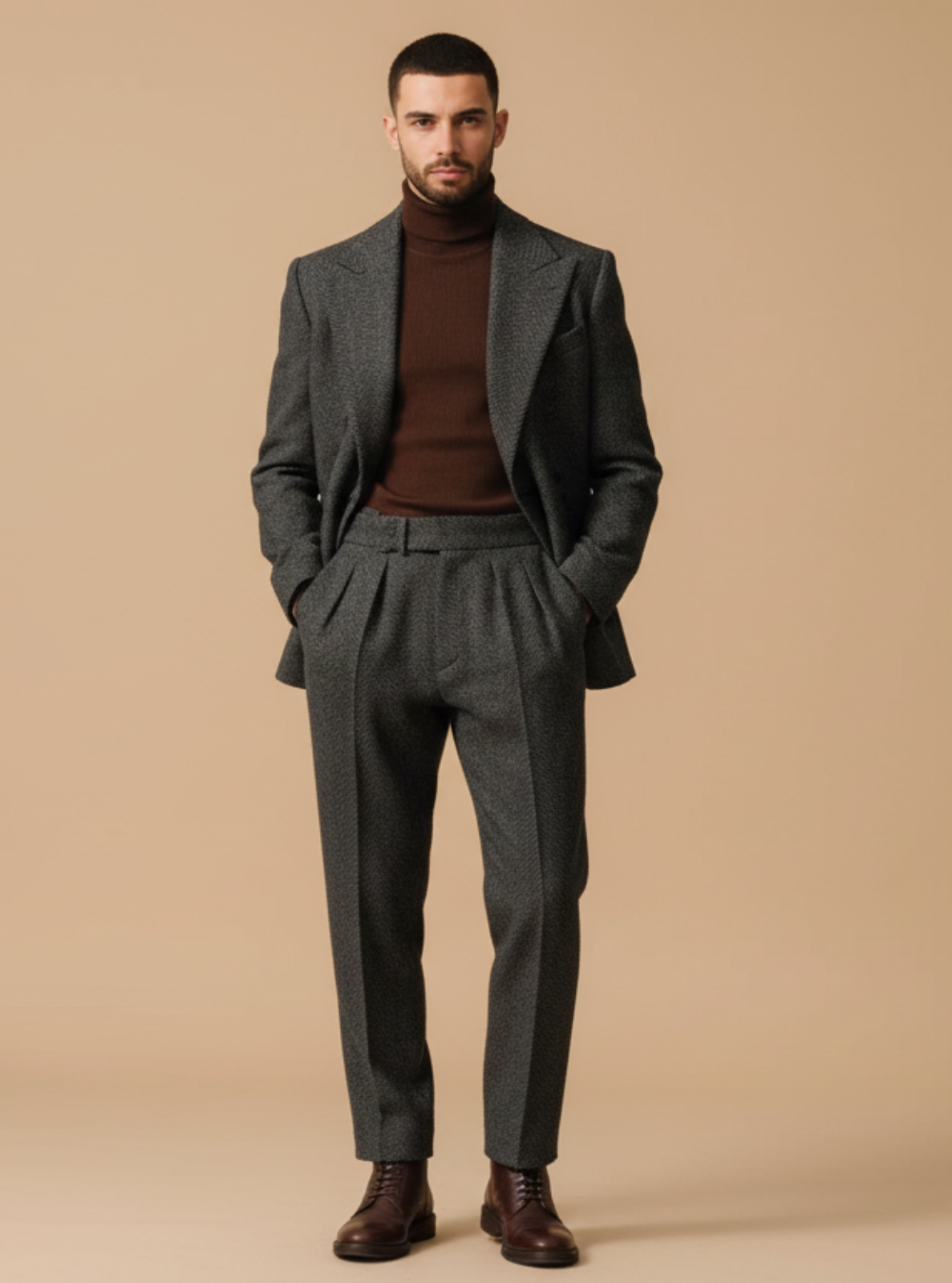Man wearing a gray suit and brown turtleneck against a beige background