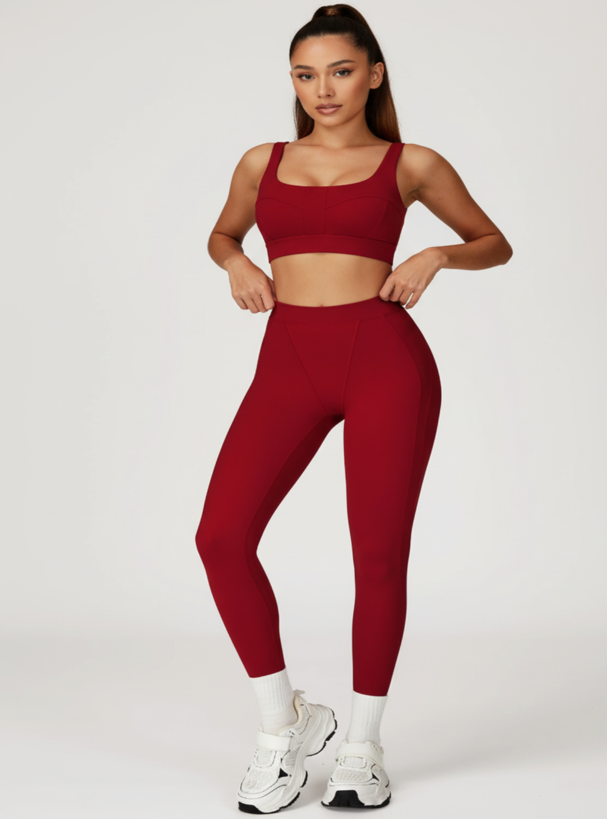 Woman wearing a red athletic outfit on a white background