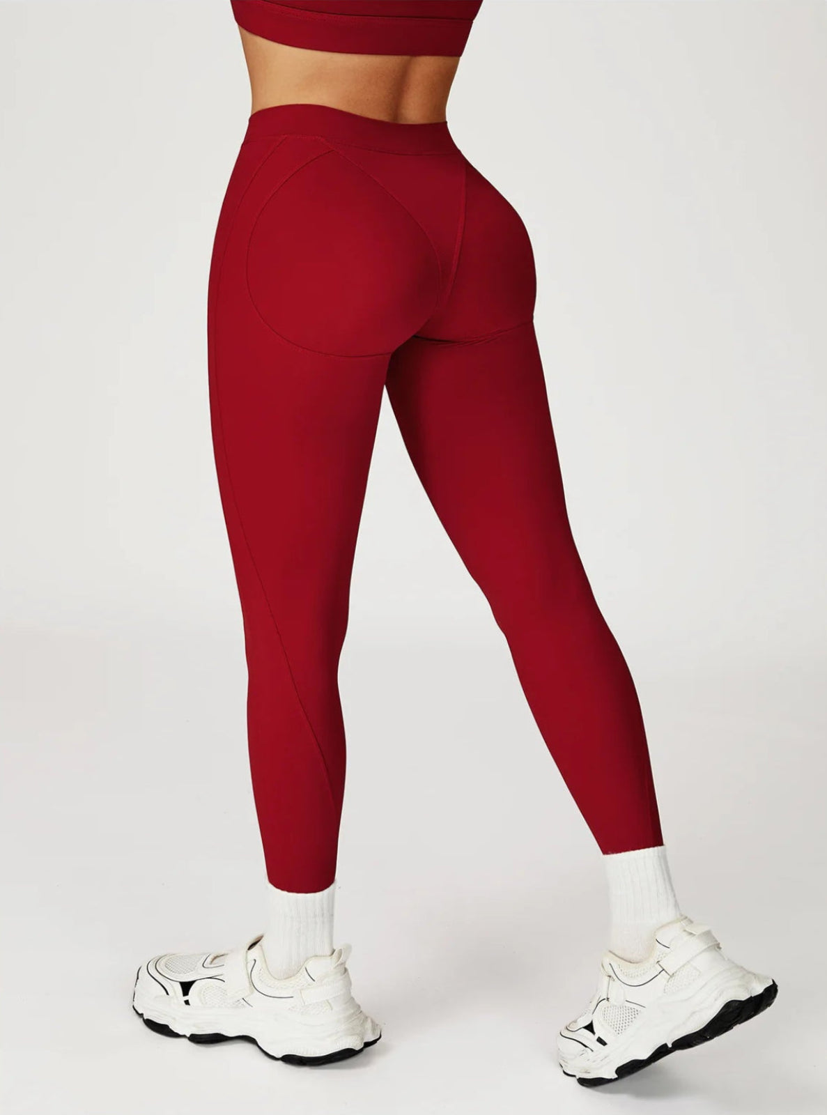 Red leggings worn by a person on a white background
