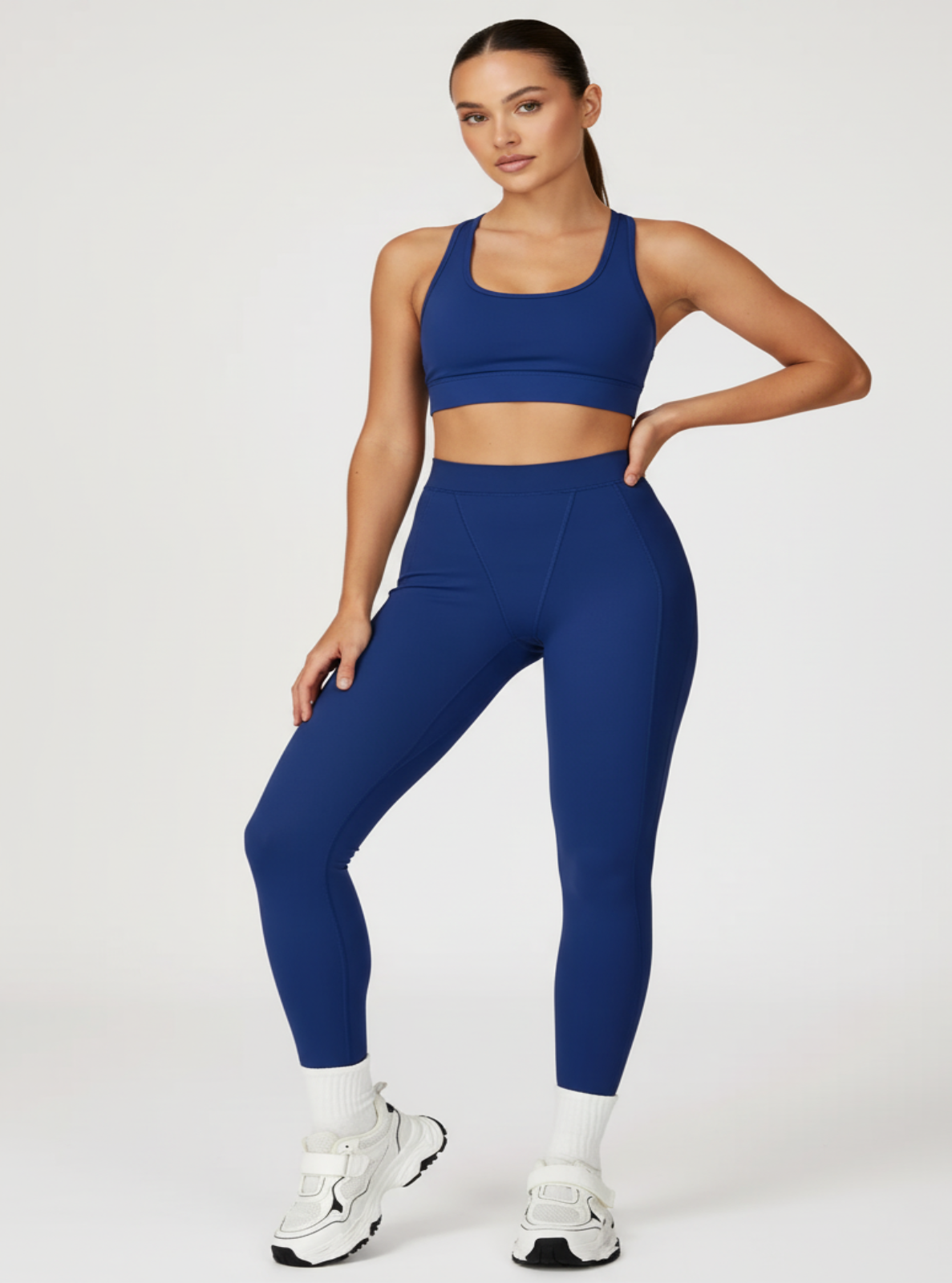 Woman wearing a blue athletic outfit on a white background