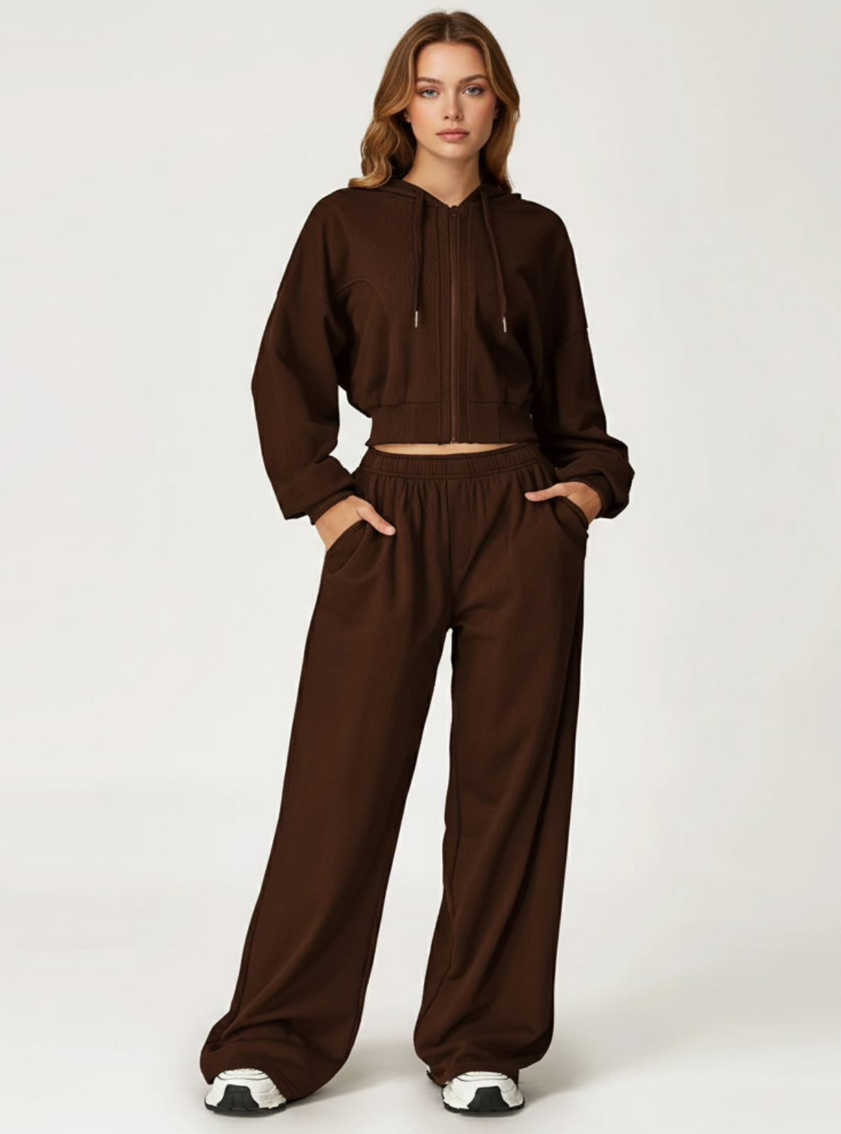 Woman wearing a brown tracksuit on a white background