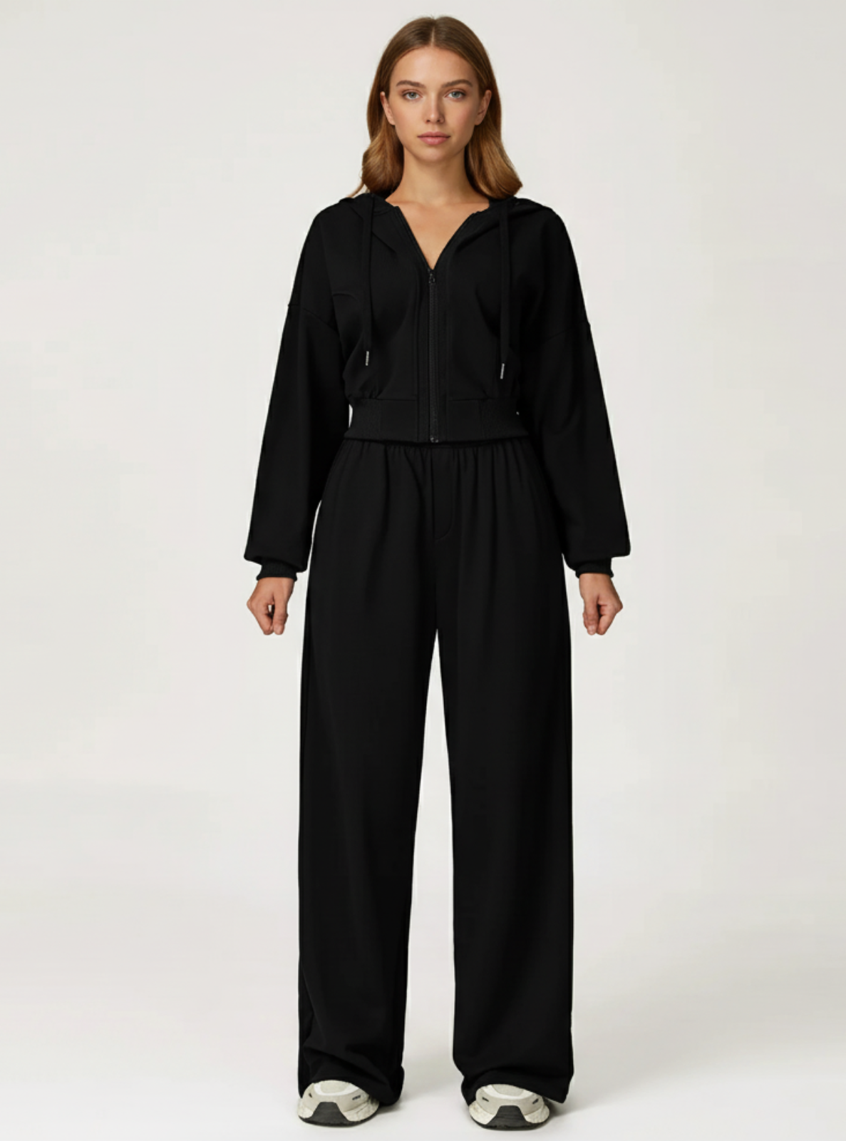 Woman wearing a black outfit on a white background