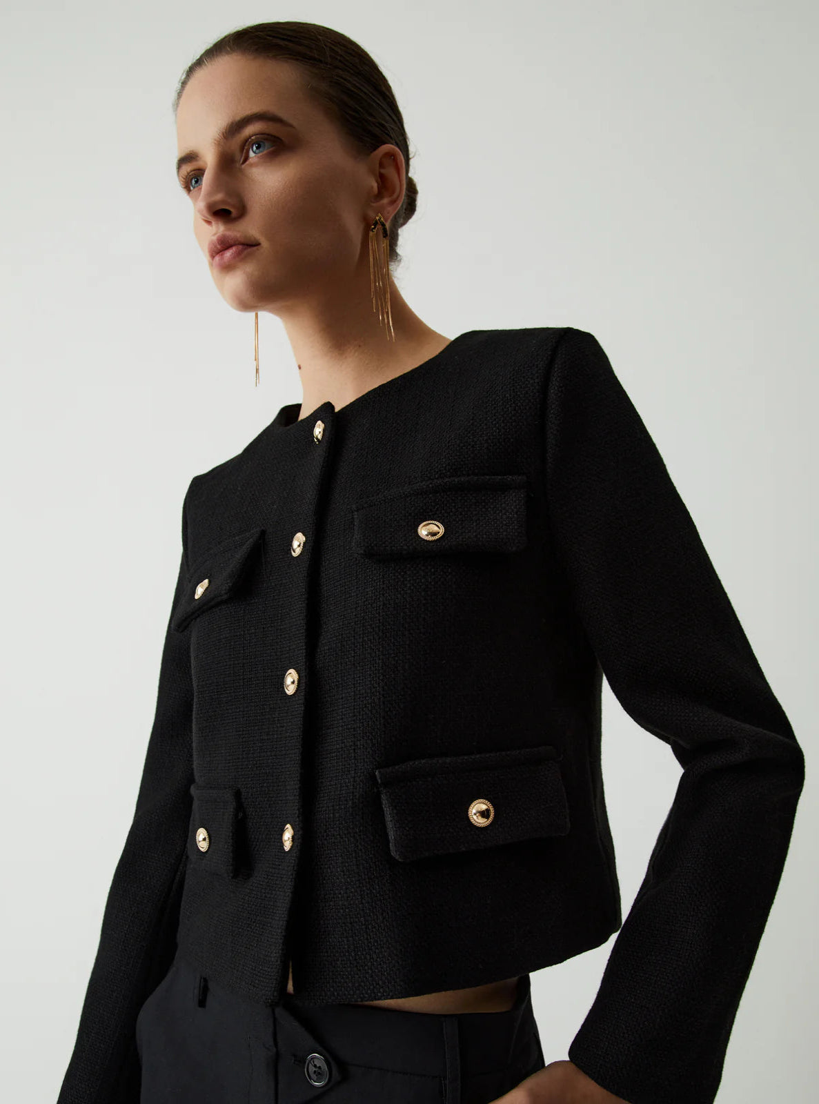 Model wearing a black textured Jacket on a white background