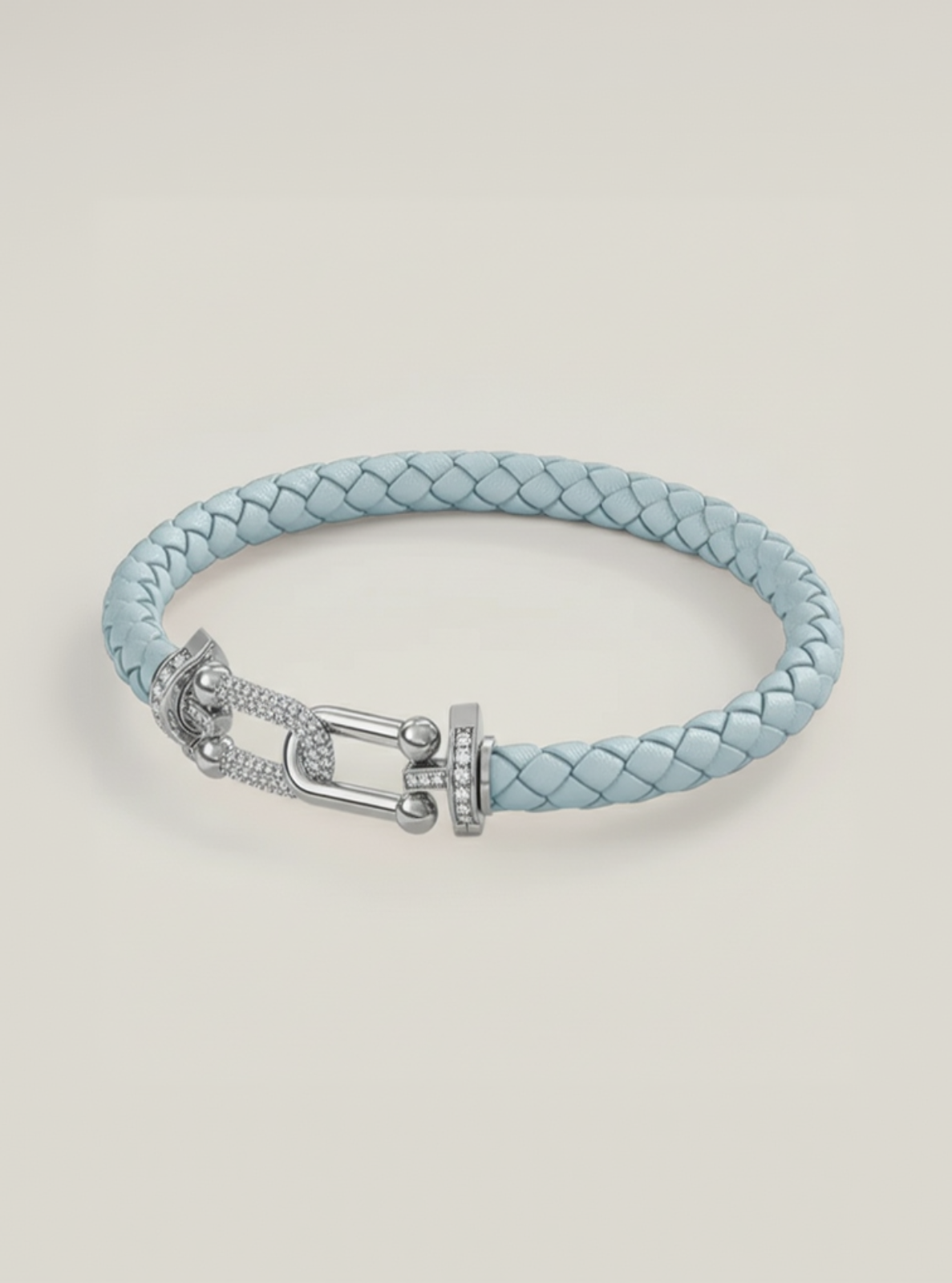 Light blue braided leather bracelet with silver clasp on a light gray background