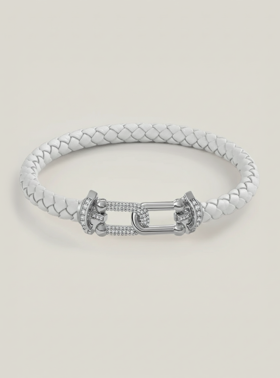 Silver bracelet with a braided design on a light gray background