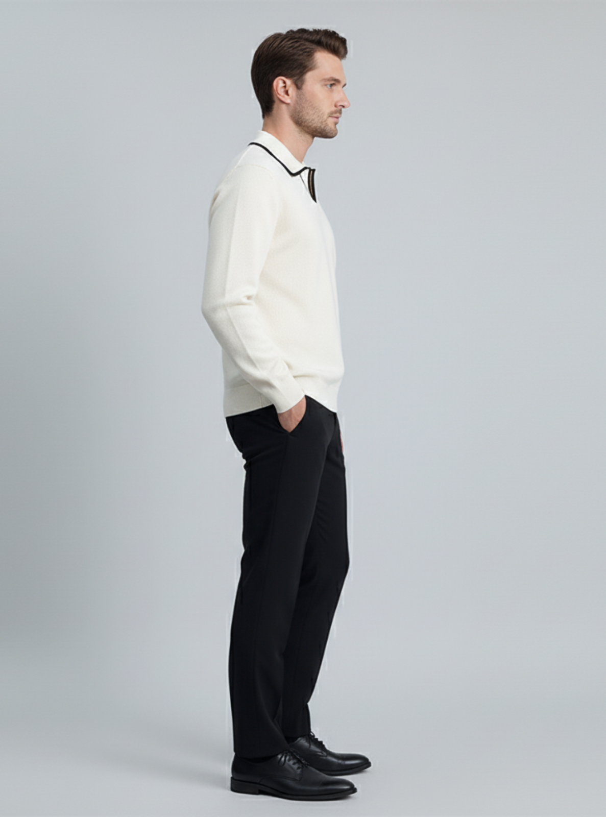 Man wearing a white shirt and black pants on a gray background