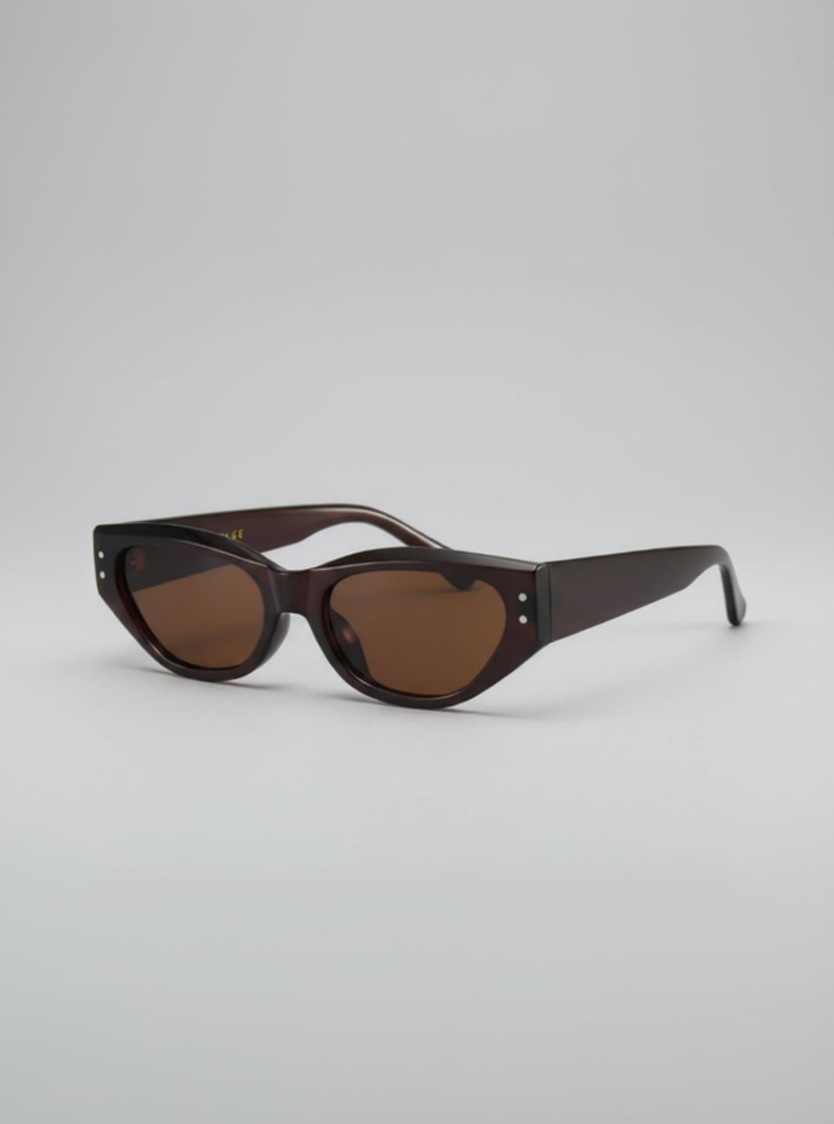 Sunglasses with brown lenses on a light gray background