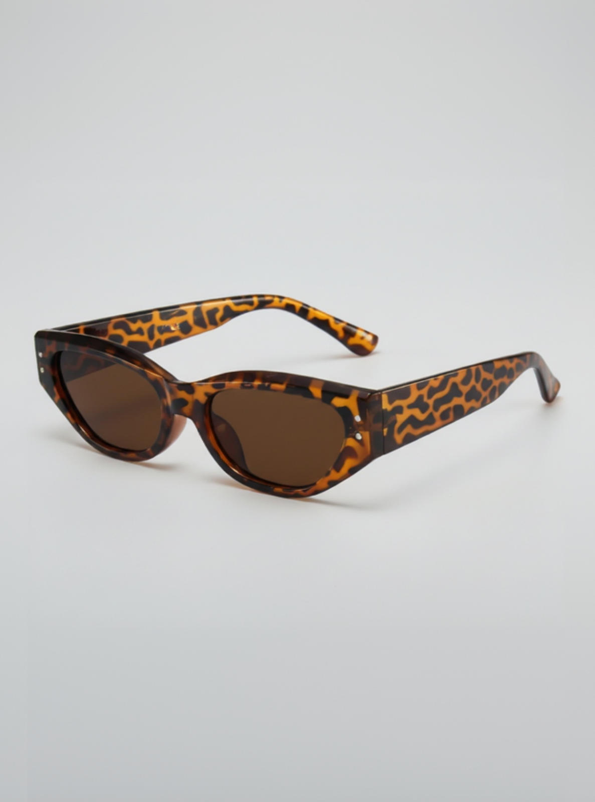 Leopard print sunglasses on a light gray background