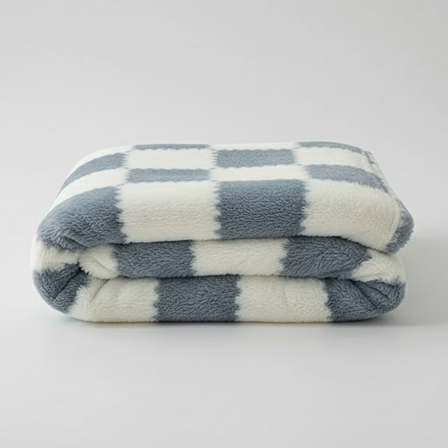 Folded checkered blanket with blue and white stripes on a light gray background