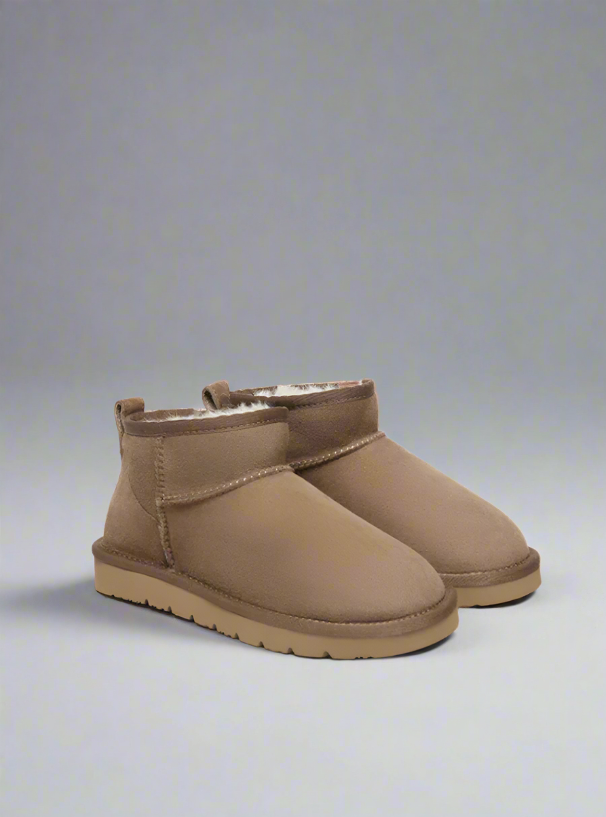 Pair of brown suede boots on a computer screen with a browser tab open.