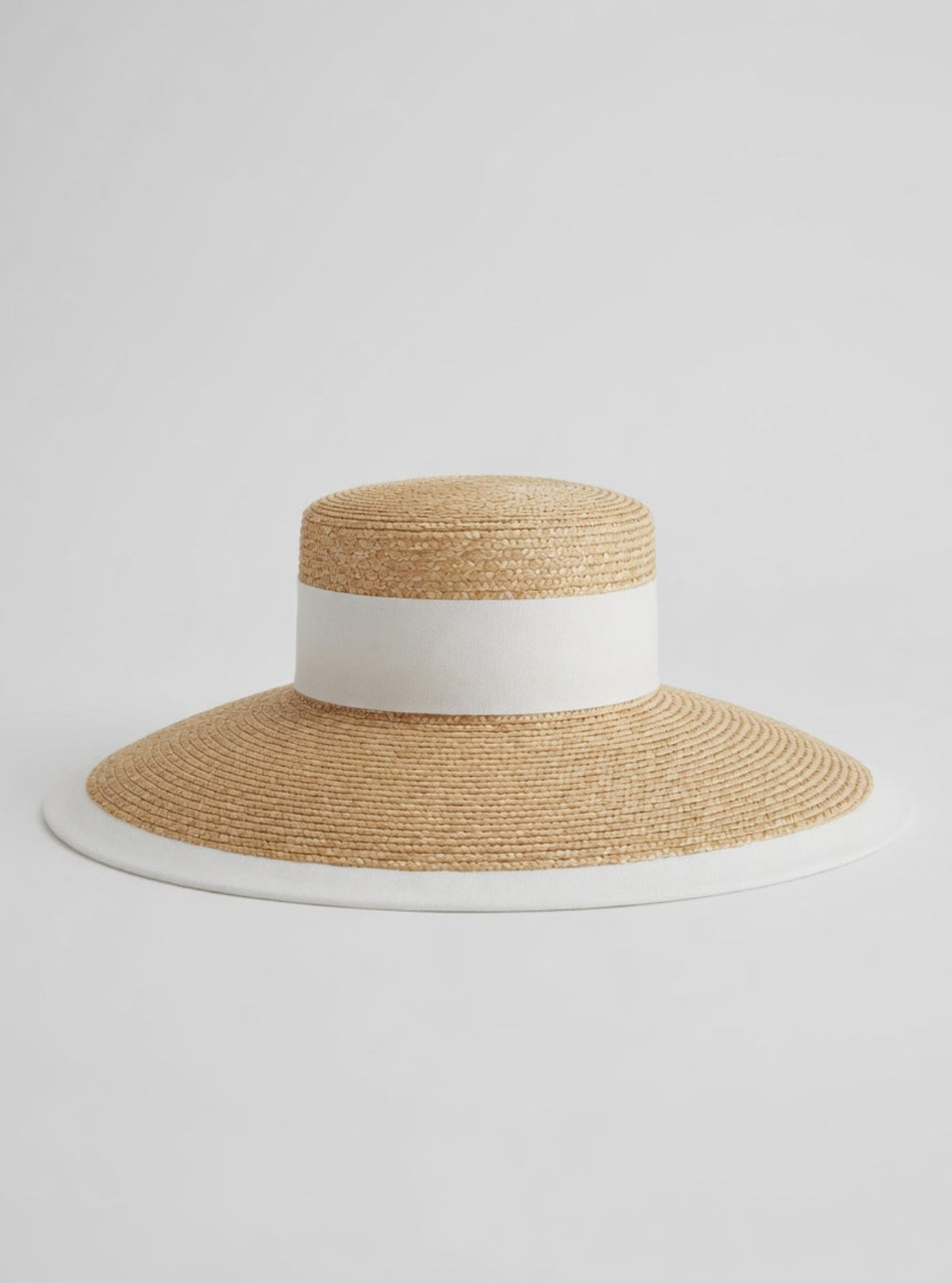 Beige straw hat with a white band on a light gray background