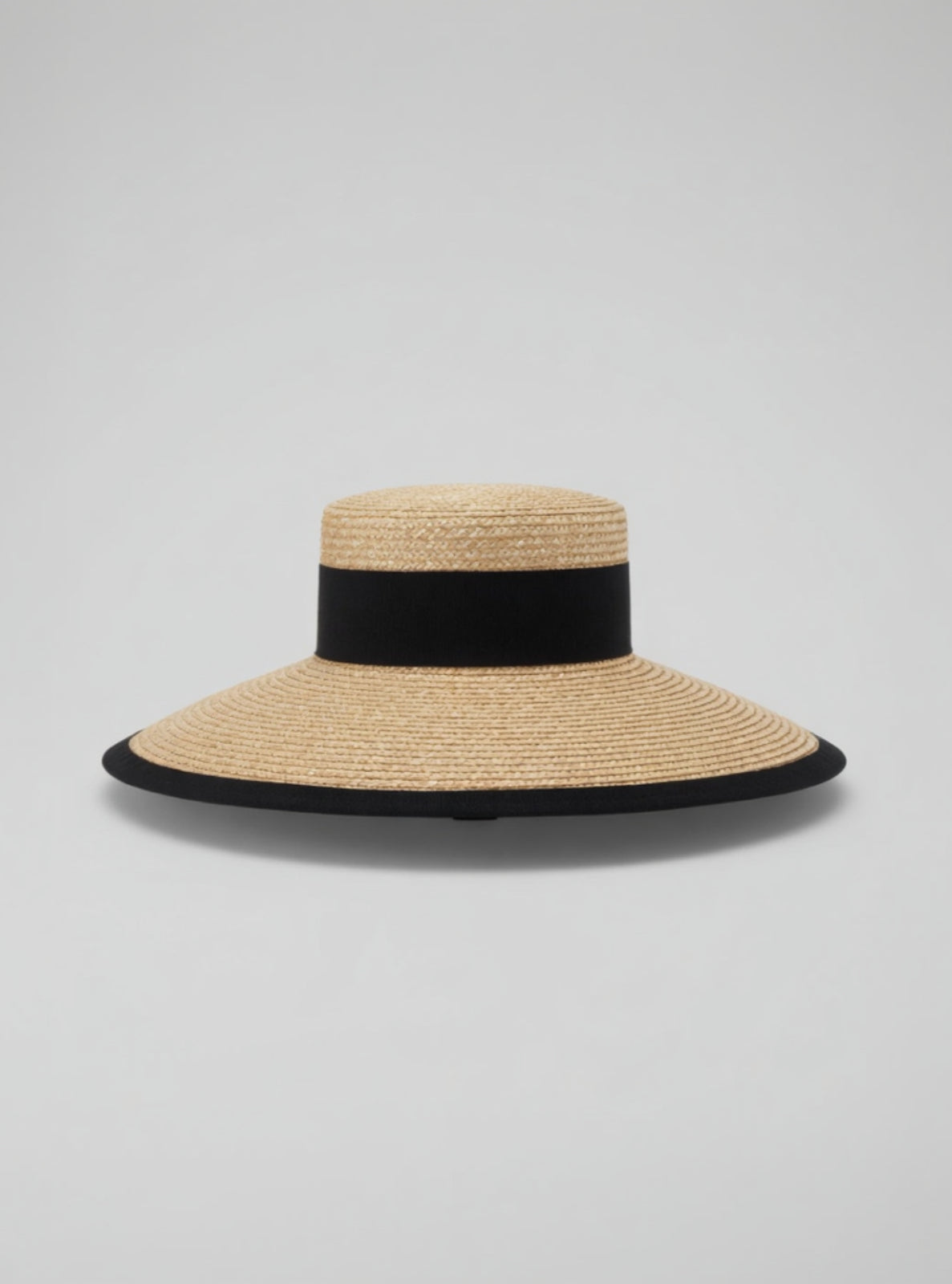 Straw hat with a black band on a gray background