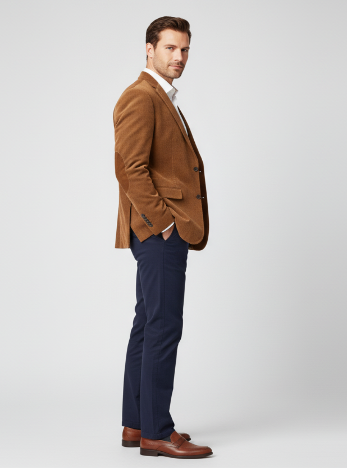 Man wearing a brown blazer and navy pants on a white background