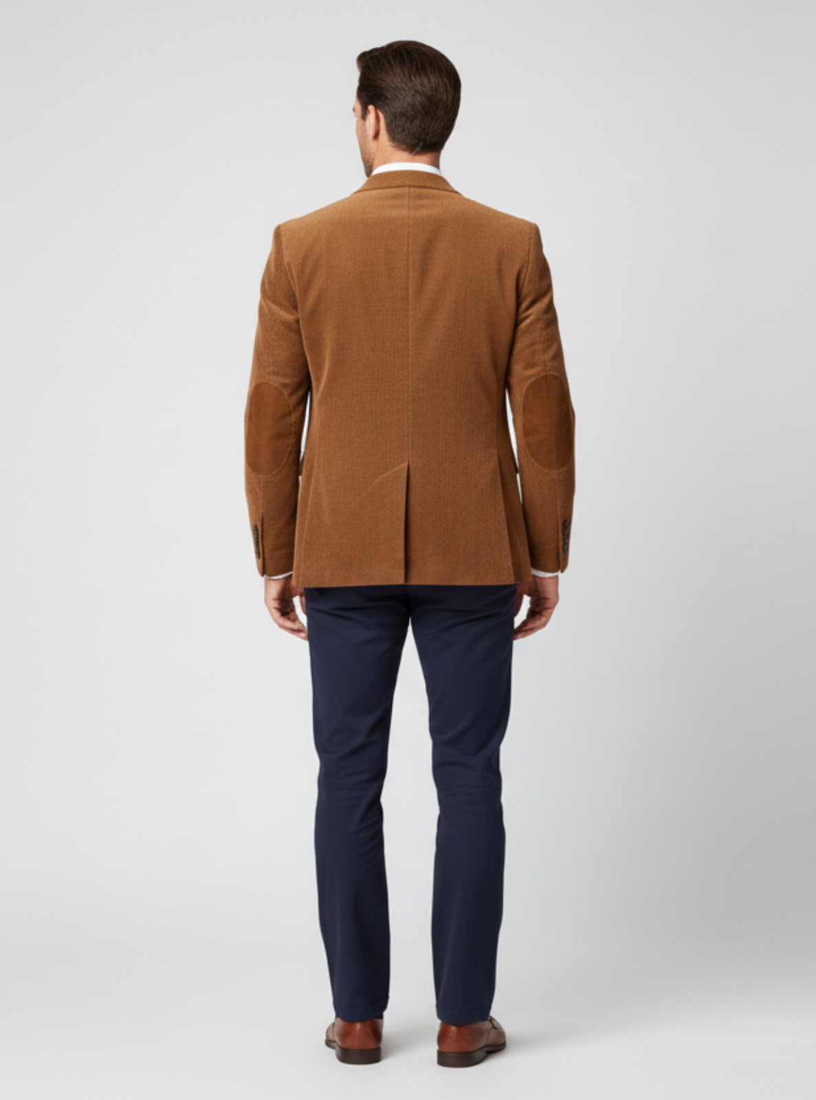 Man wearing a brown jacket and dark blue pants on a white background