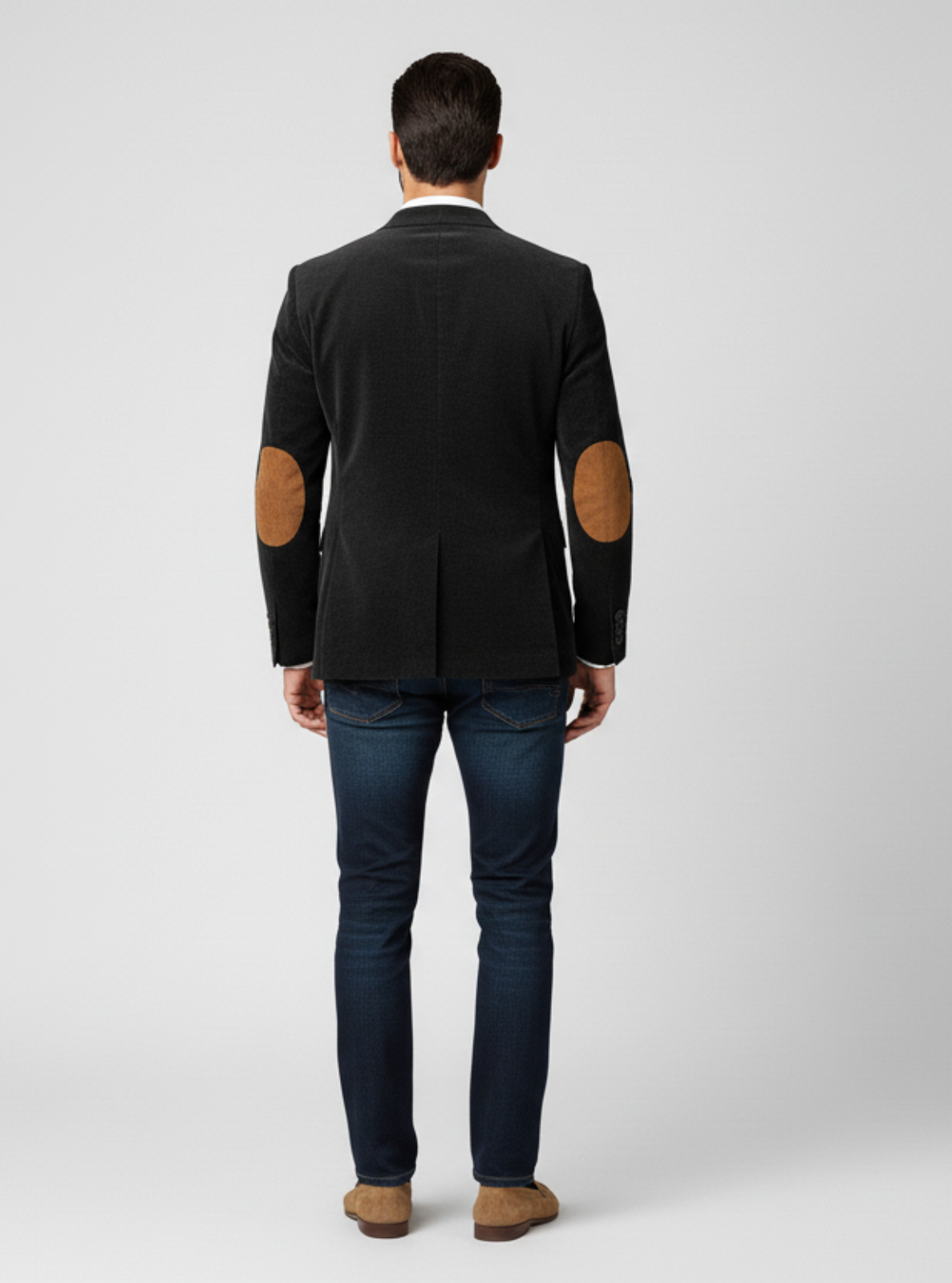 Man wearing a black jacket with brown elbow patches on a white background