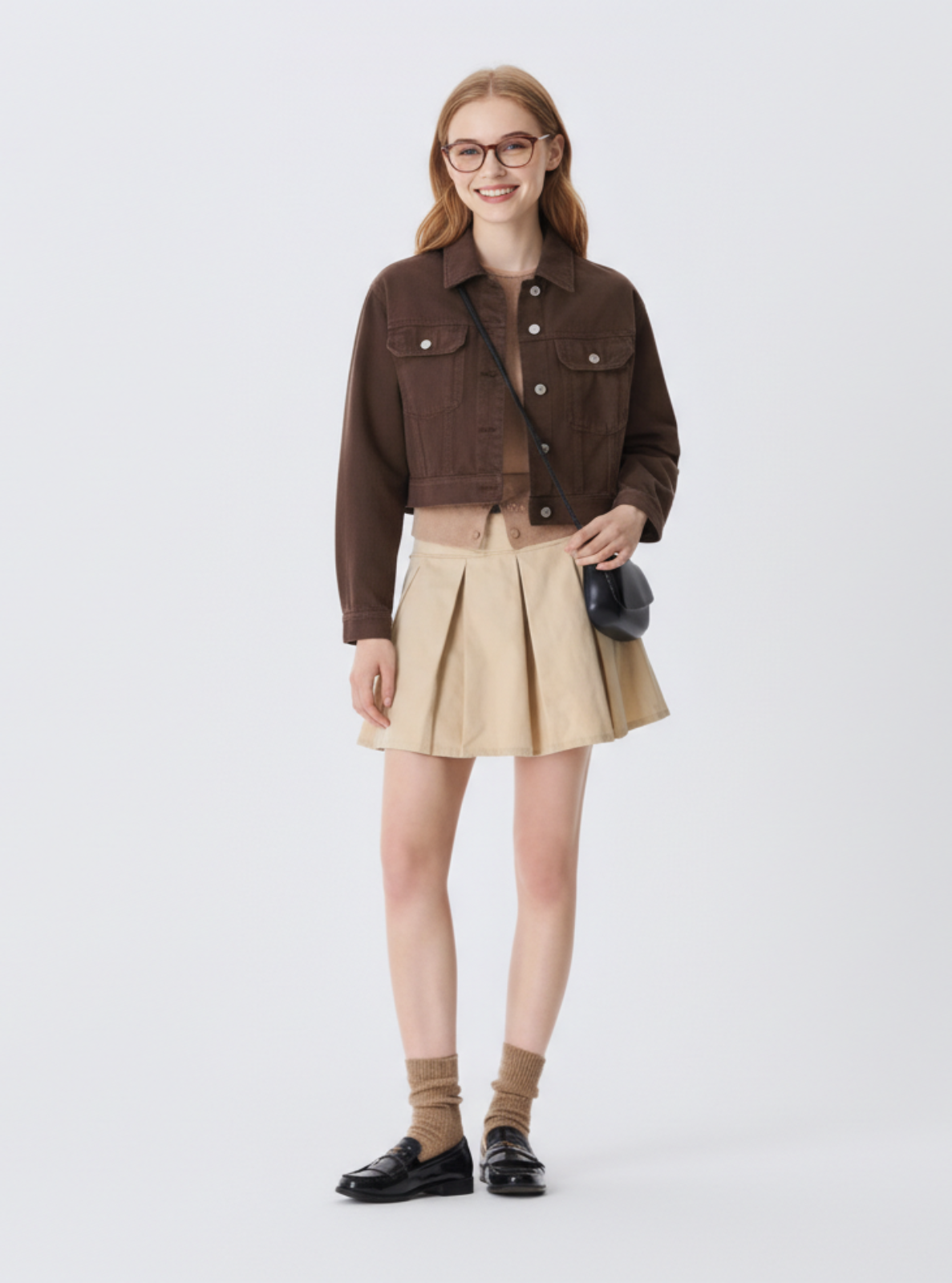 Woman wearing a brown jacket and beige skirt on a white background