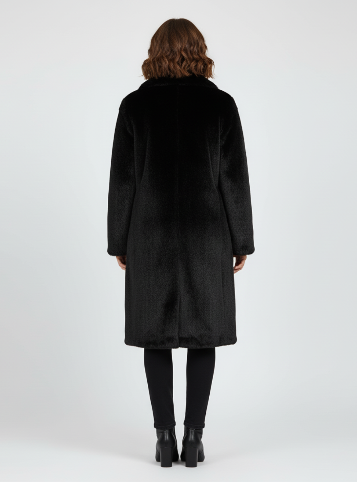 Person wearing a black coat on a white background