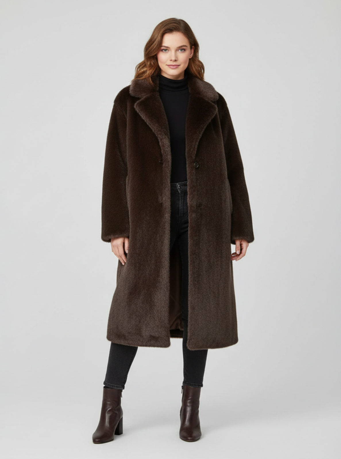 Woman wearing a brown coat on a light gray background