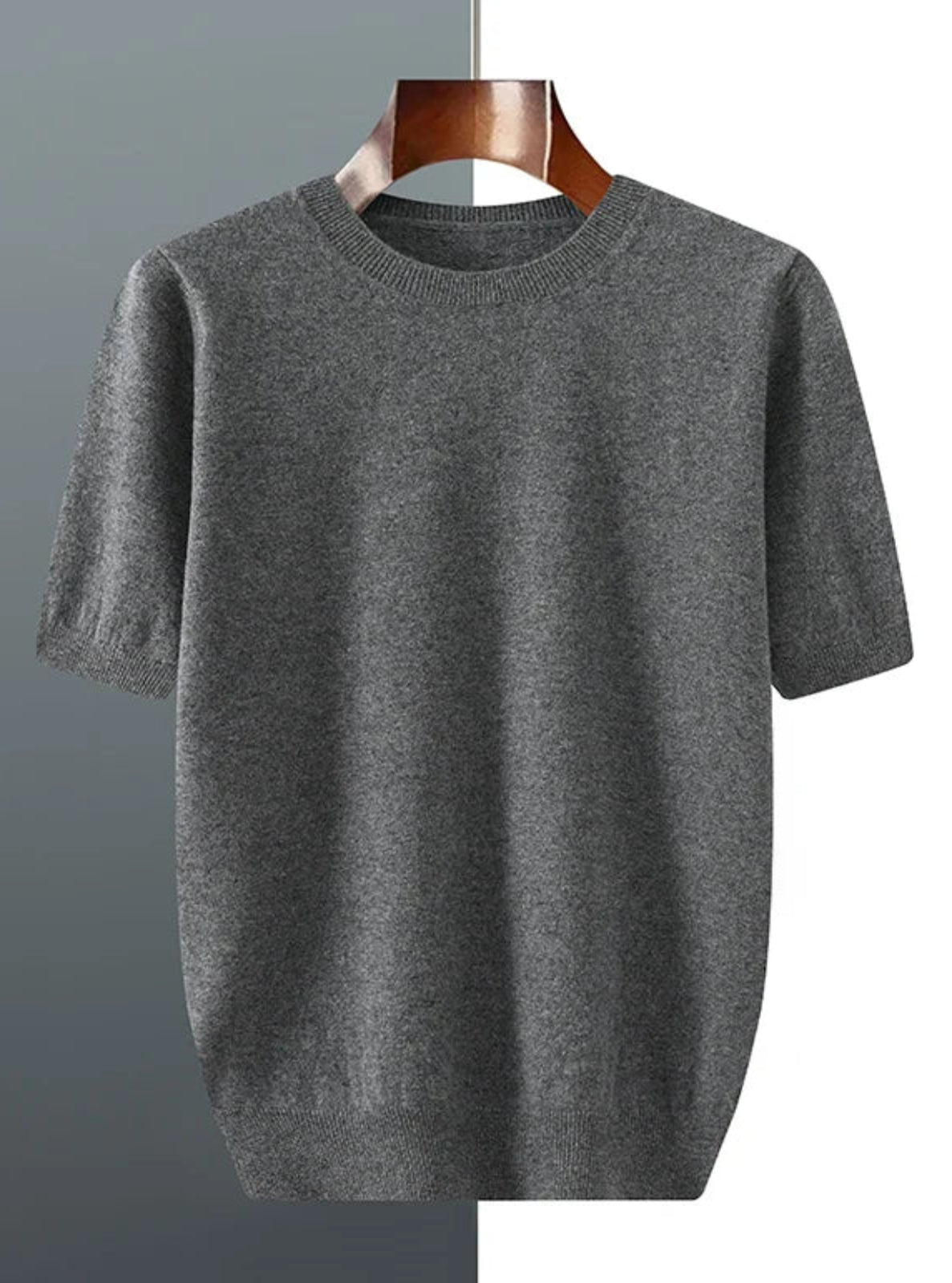 Gray t-shirt on a wooden hanger against a gradient background