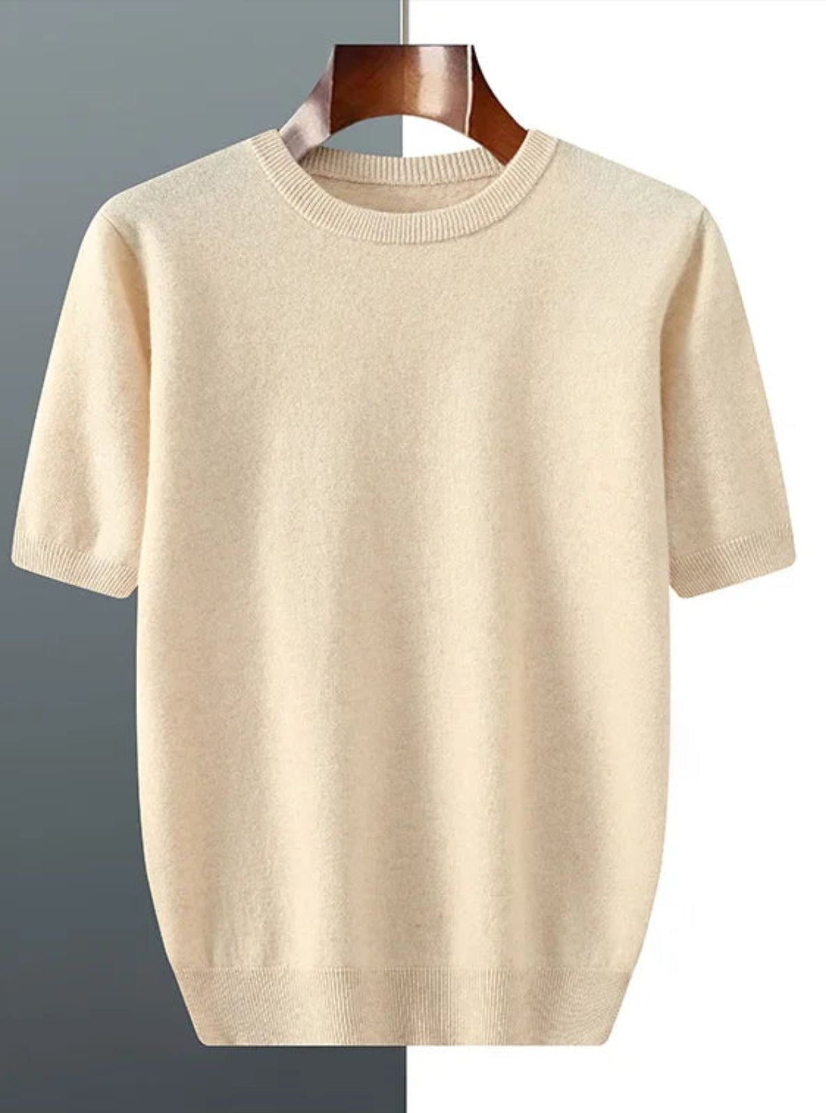 Beige sweater on a hanger against a gradient background