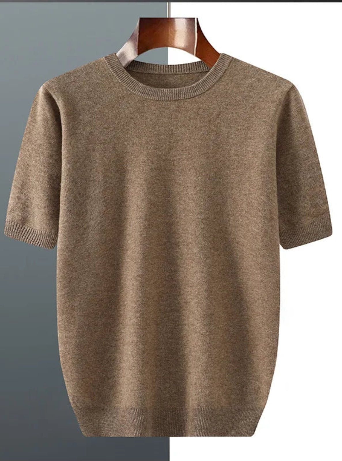 Brown sweater on a hanger against a gray background