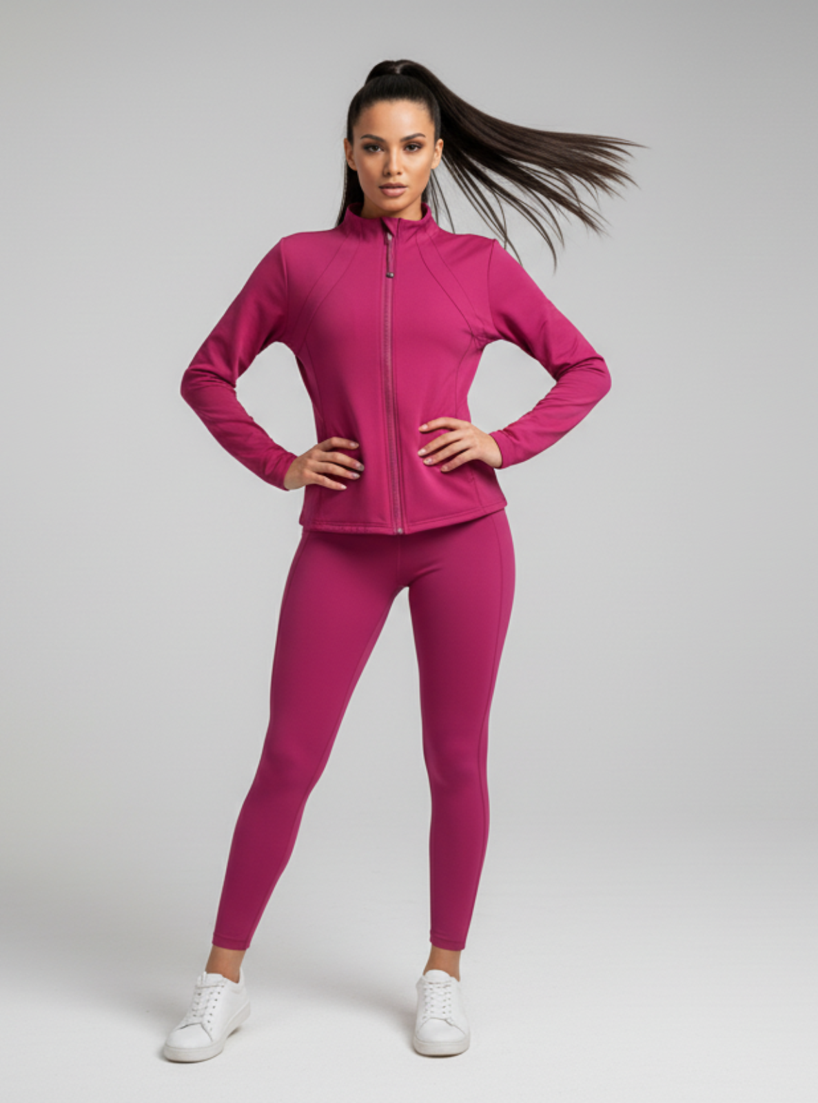 Woman wearing a pink athletic outfit on a gray background