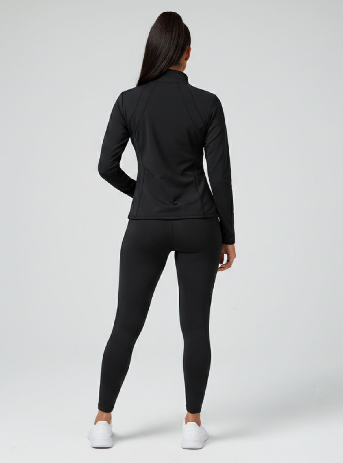 Person wearing a black athletic outfit on a white background