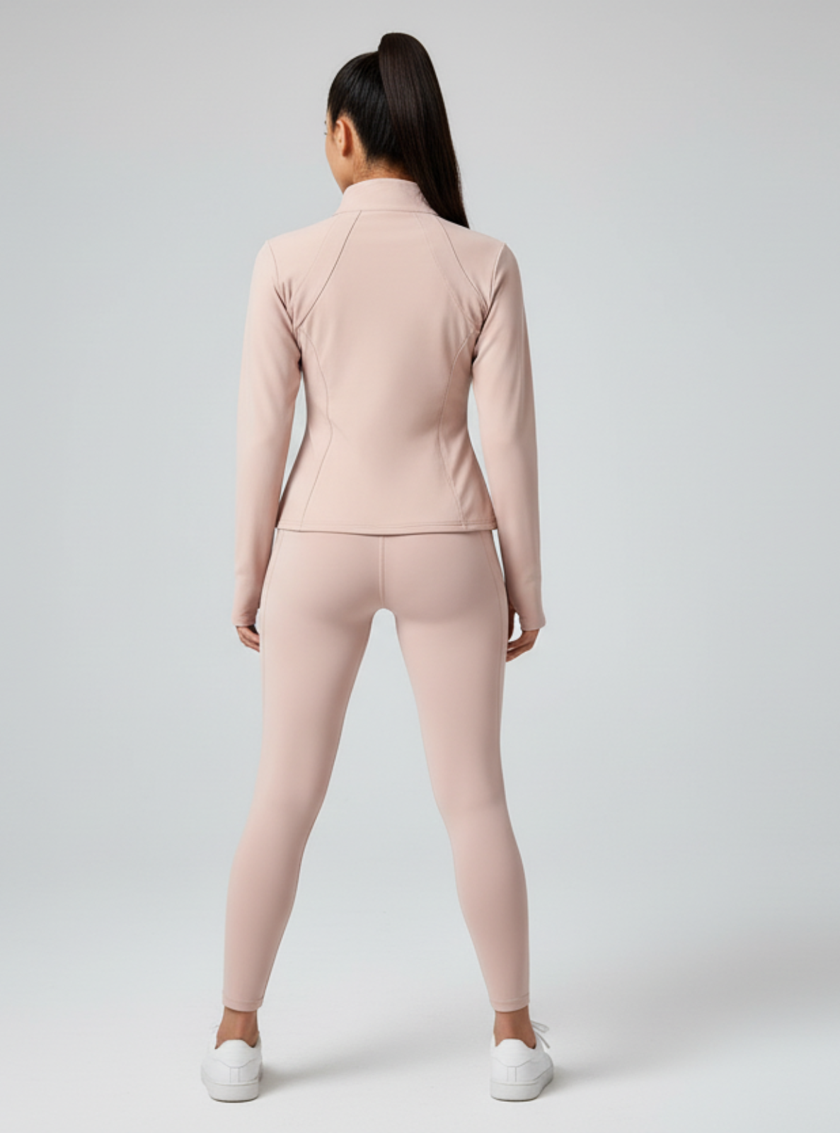 Person wearing a light pink athletic outfit on a white background