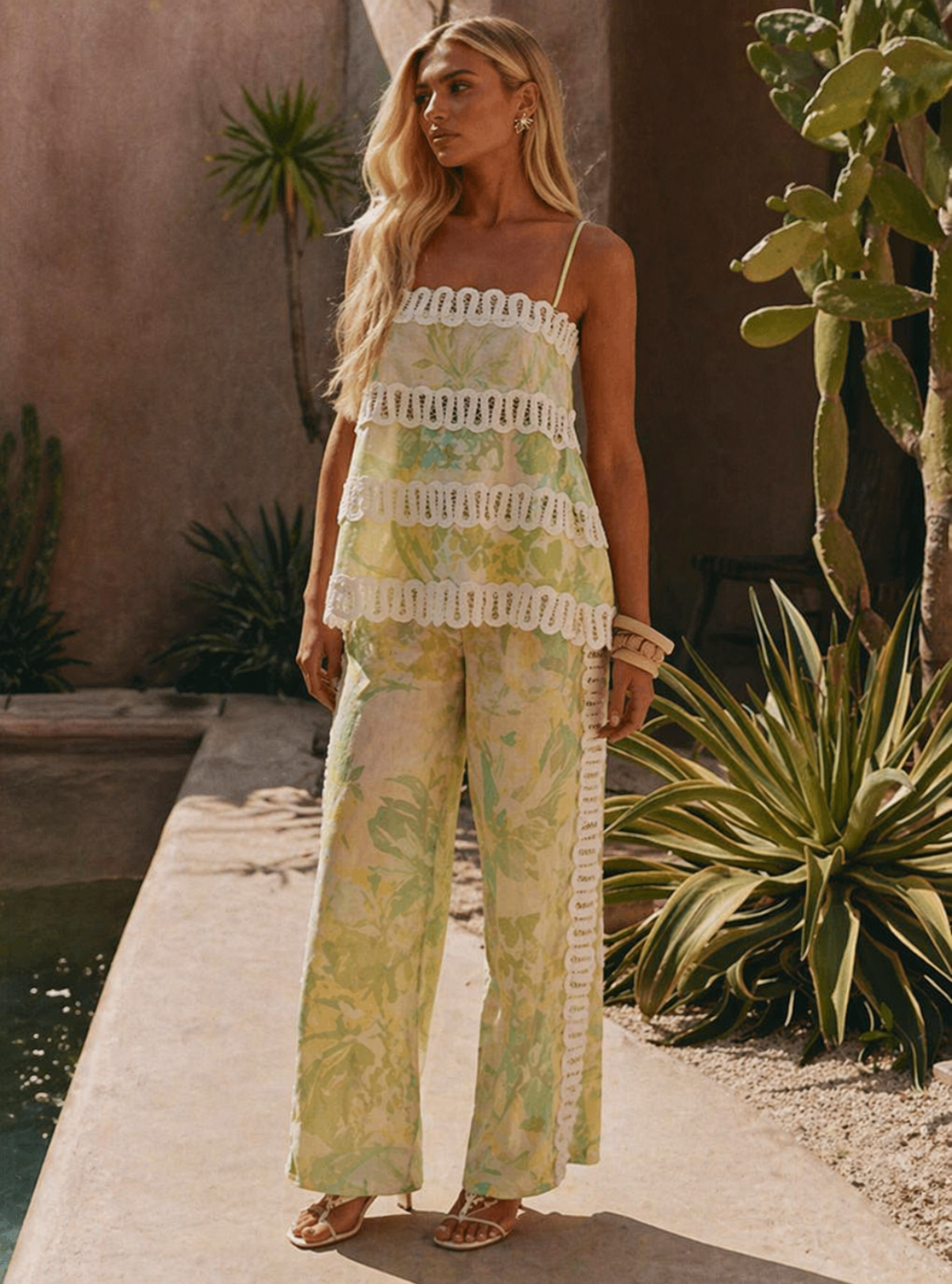 Woman in a floral outfit standing in a desert-like setting with cacti.