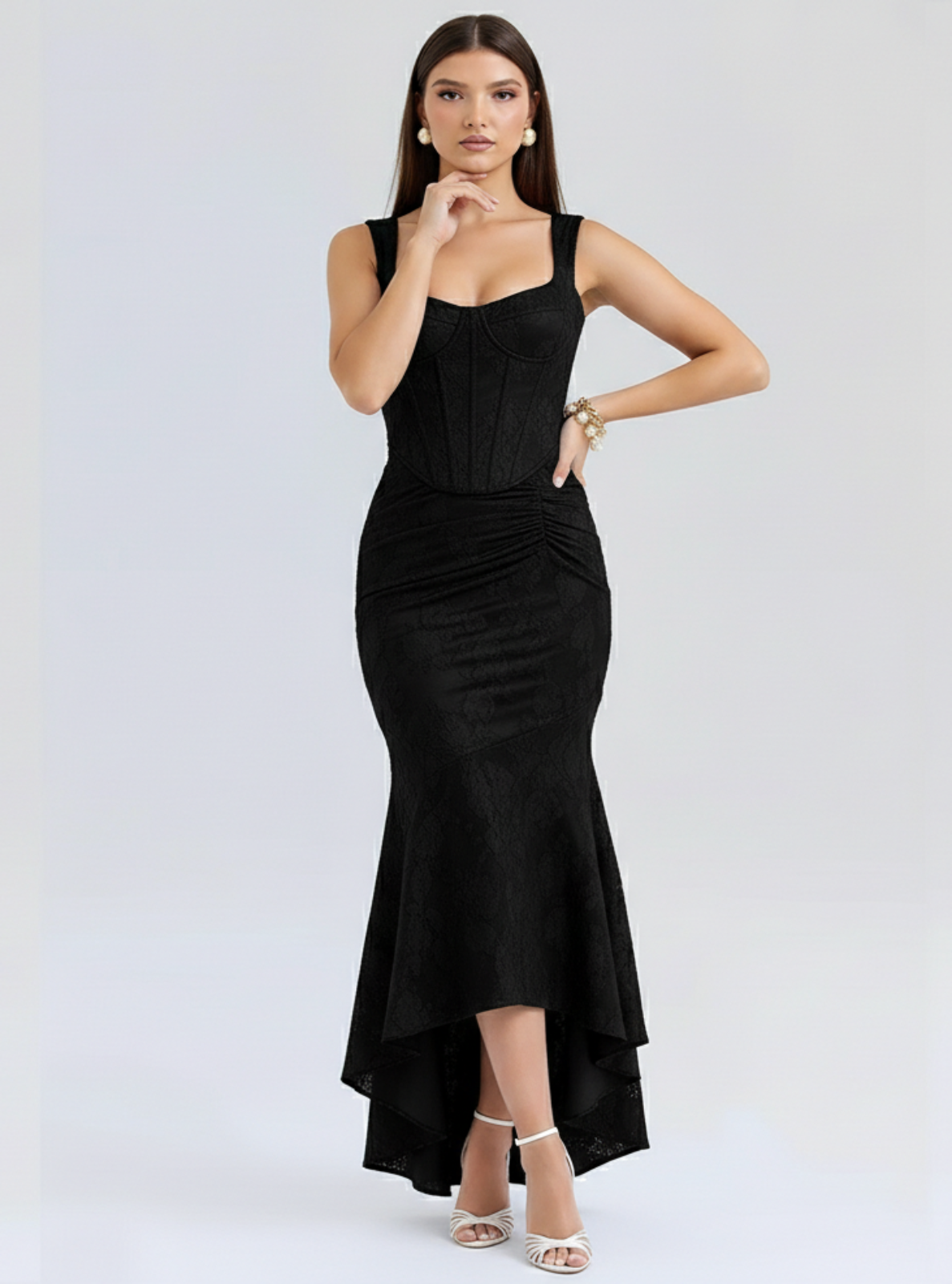 Woman wearing a black sleeveless dress on a white background