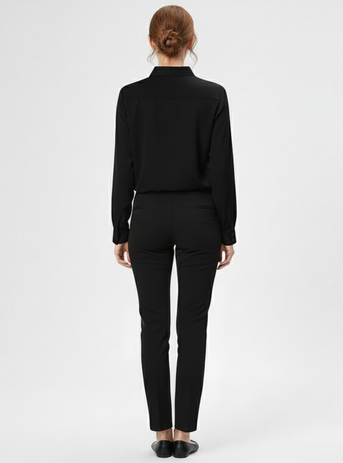 Person wearing a black suit on a white background