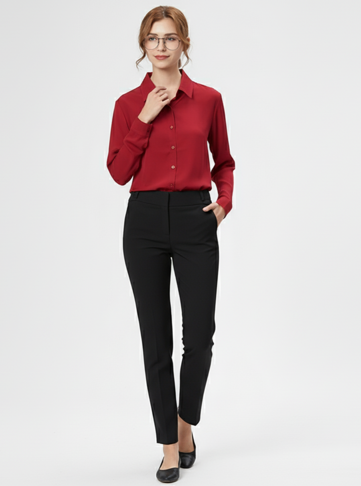 Woman wearing a red blouse and black pants on a white background