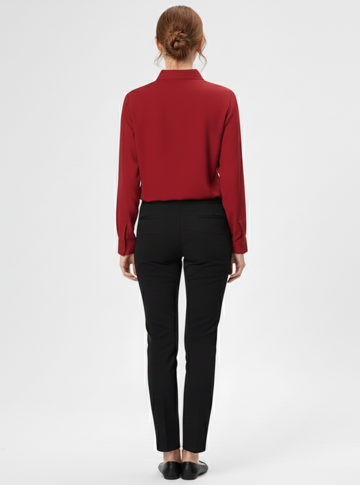 Person wearing a red blouse and black pants on a white background