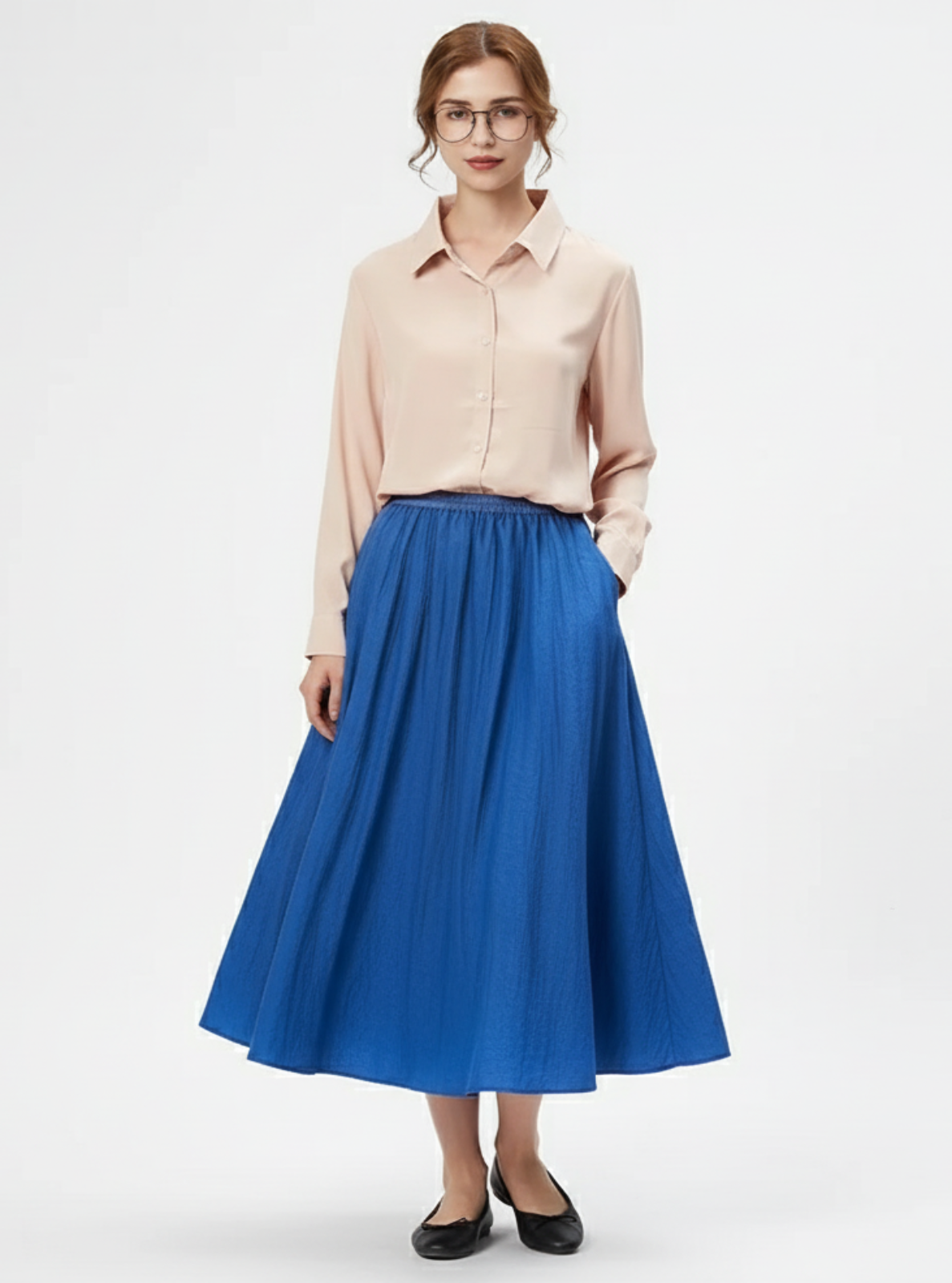 Woman wearing a beige blouse and blue skirt on a white background