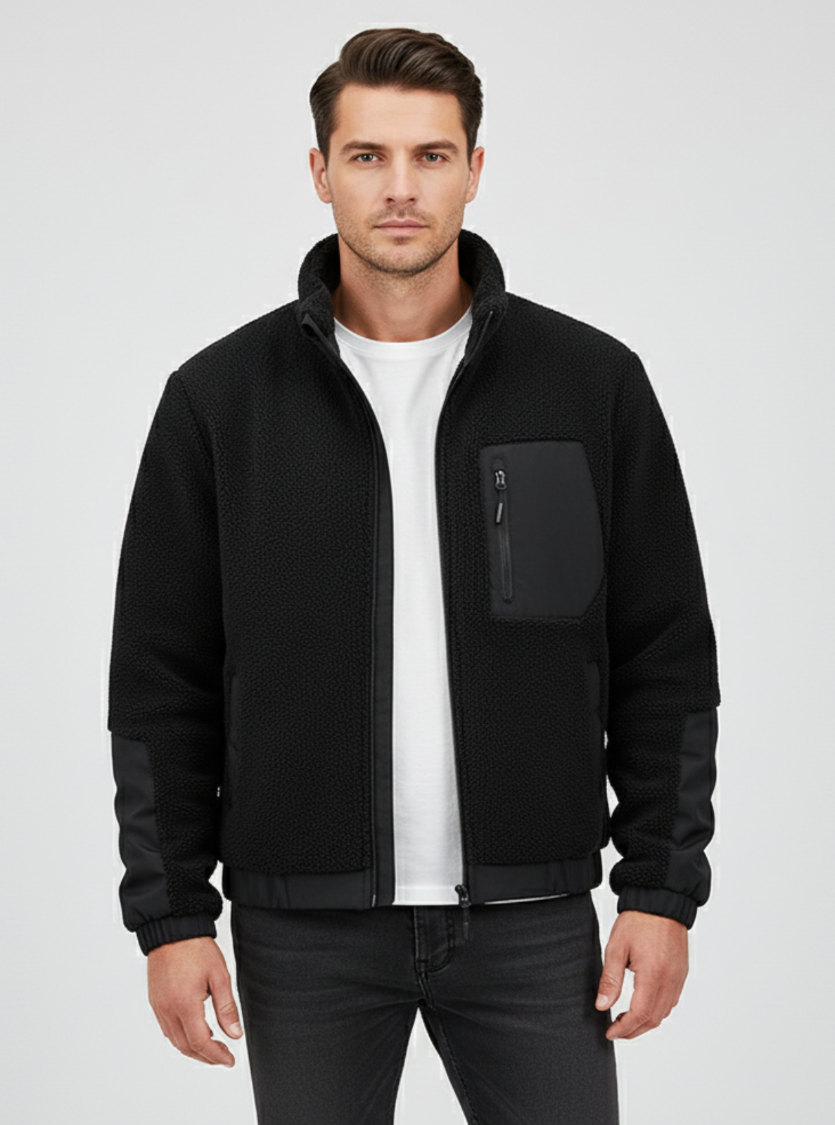 Man wearing a black jacket on a gray background