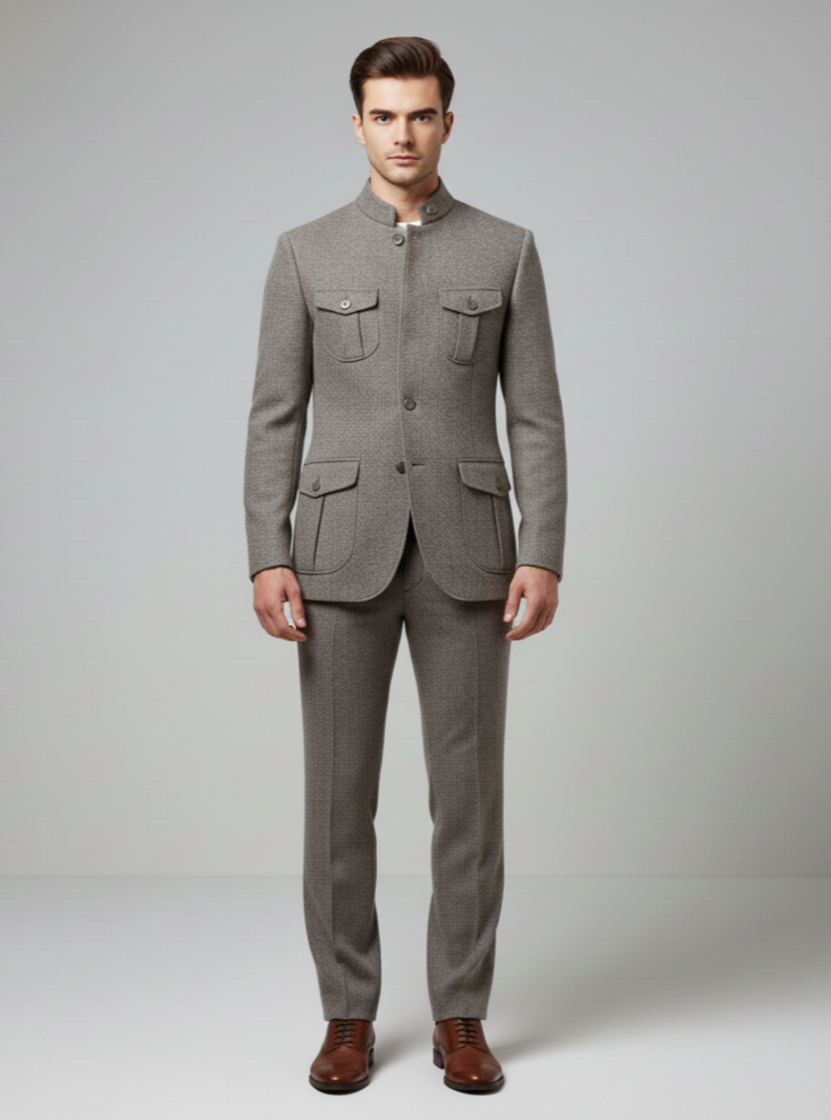 Man wearing a gray suit with brown shoes on a plain background