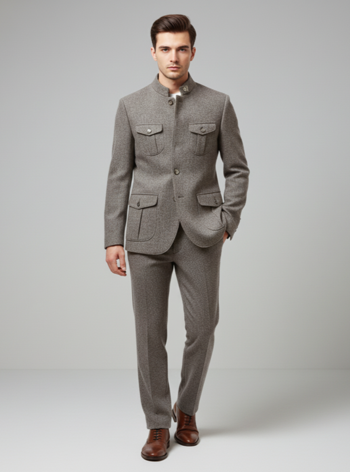 Man wearing a gray suit with brown shoes on a light gray background
