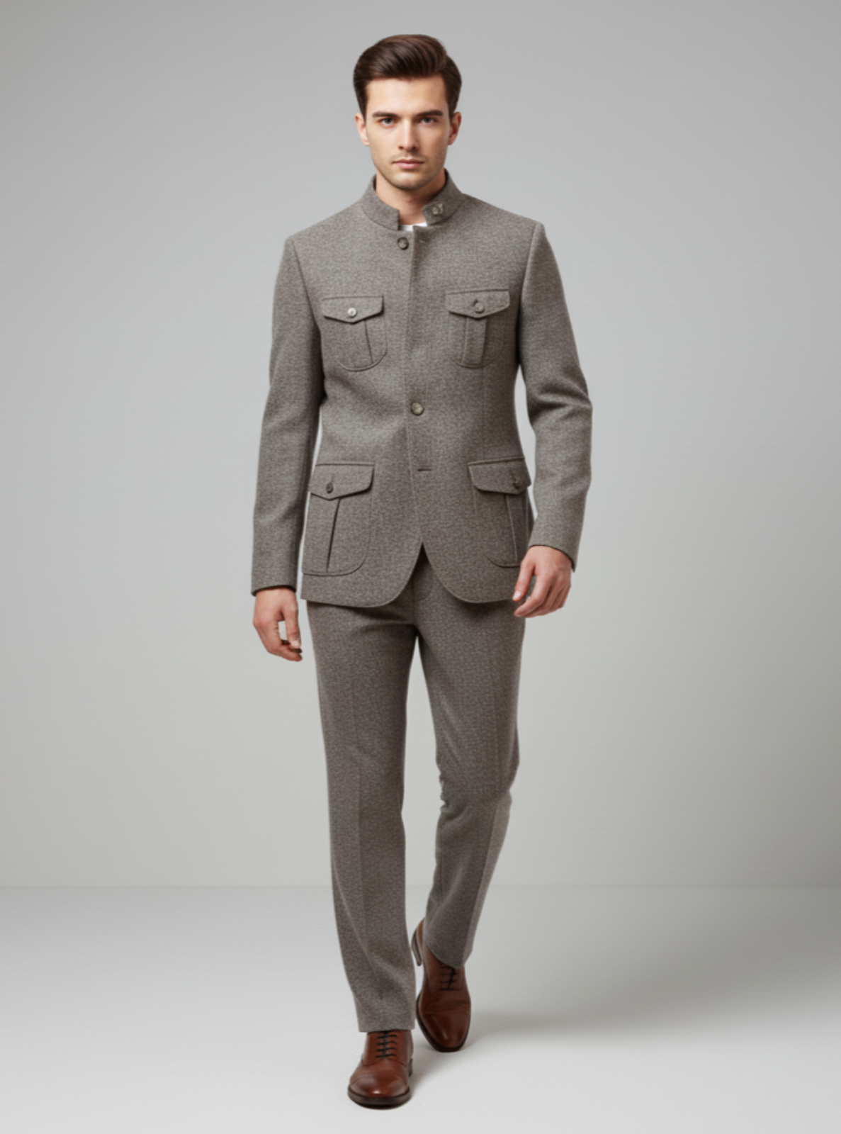 Man wearing a gray suit with brown shoes on a plain background