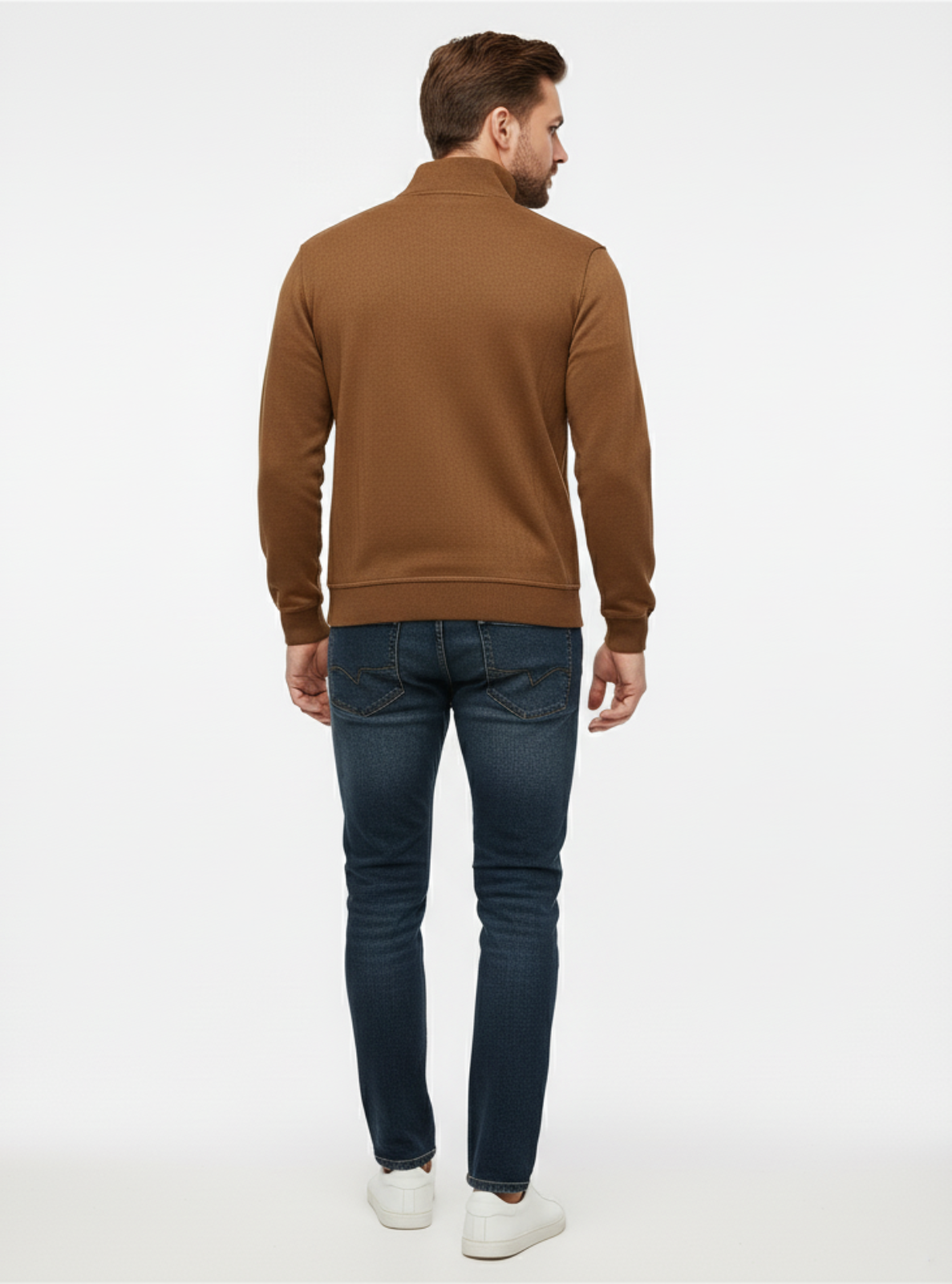 Man wearing a brown jacket and blue jeans on a white background