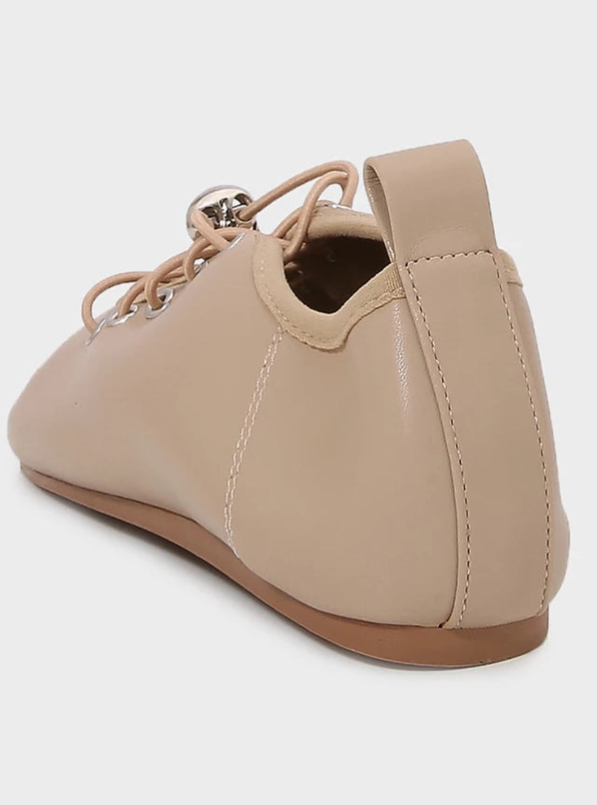 Beige leather shoe with a back strap on a white background