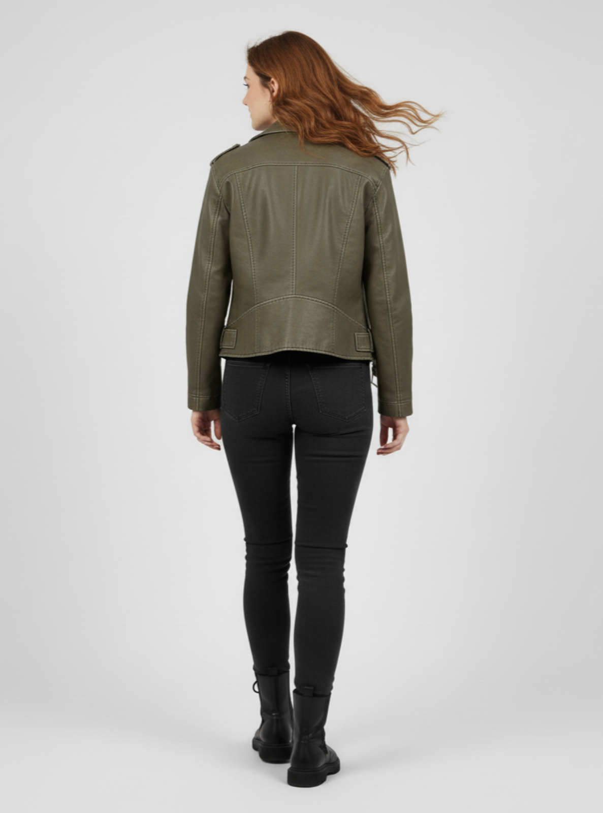 Woman wearing a green leather jacket on a white background