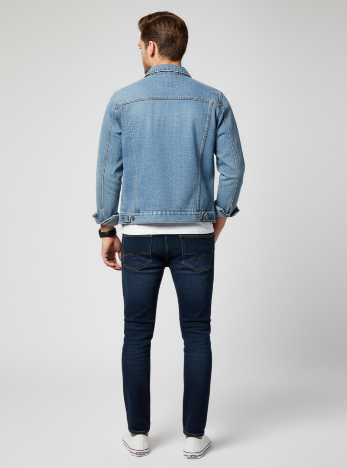 Man wearing a denim jacket and jeans on a white background