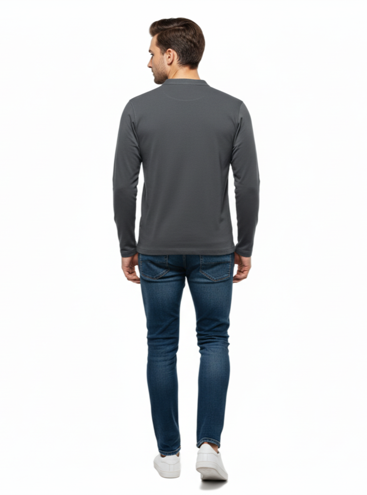 Man wearing a gray long-sleeve shirt and blue jeans on a white background
