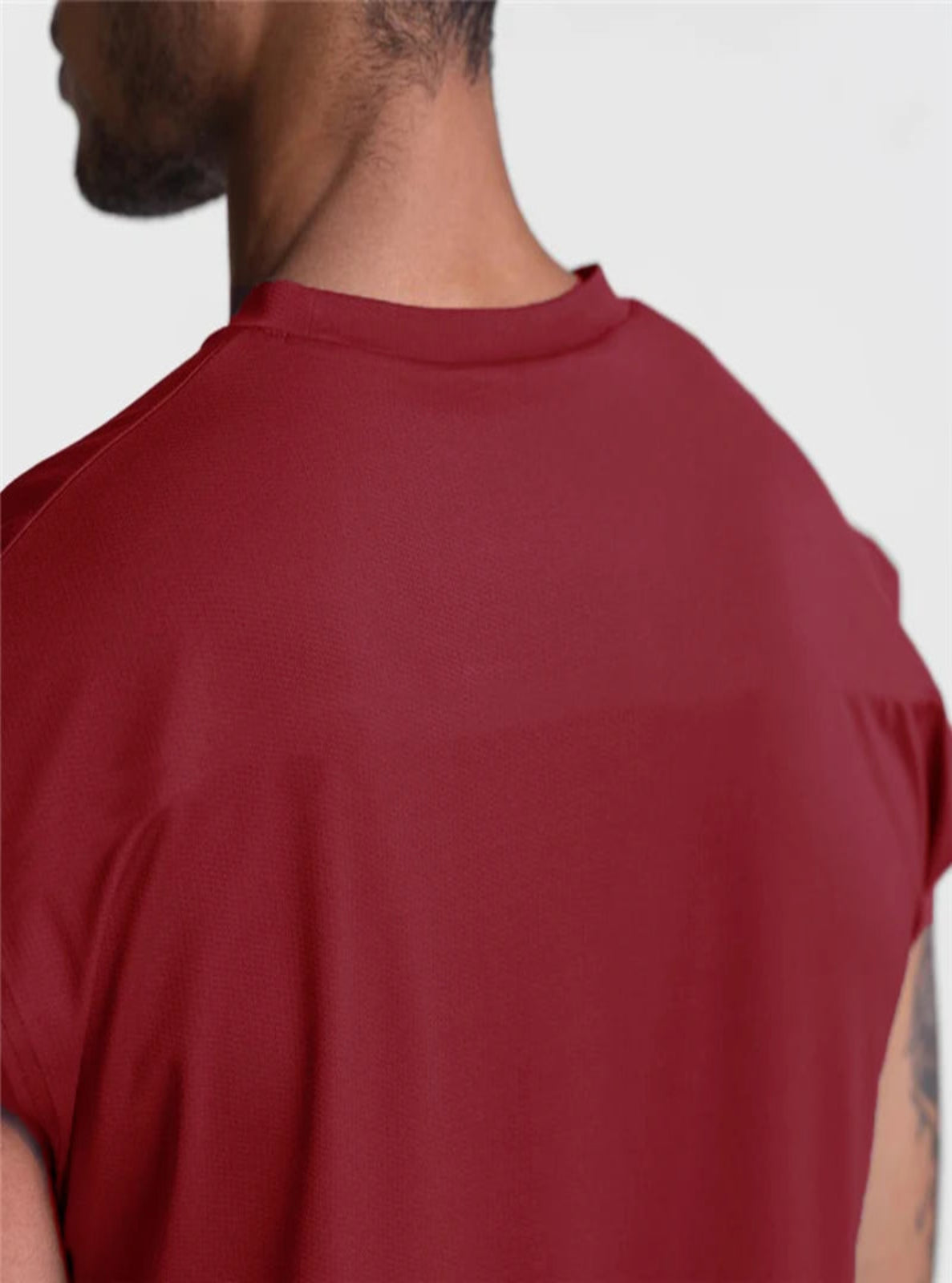 Red t-shirt worn by a person on a white background