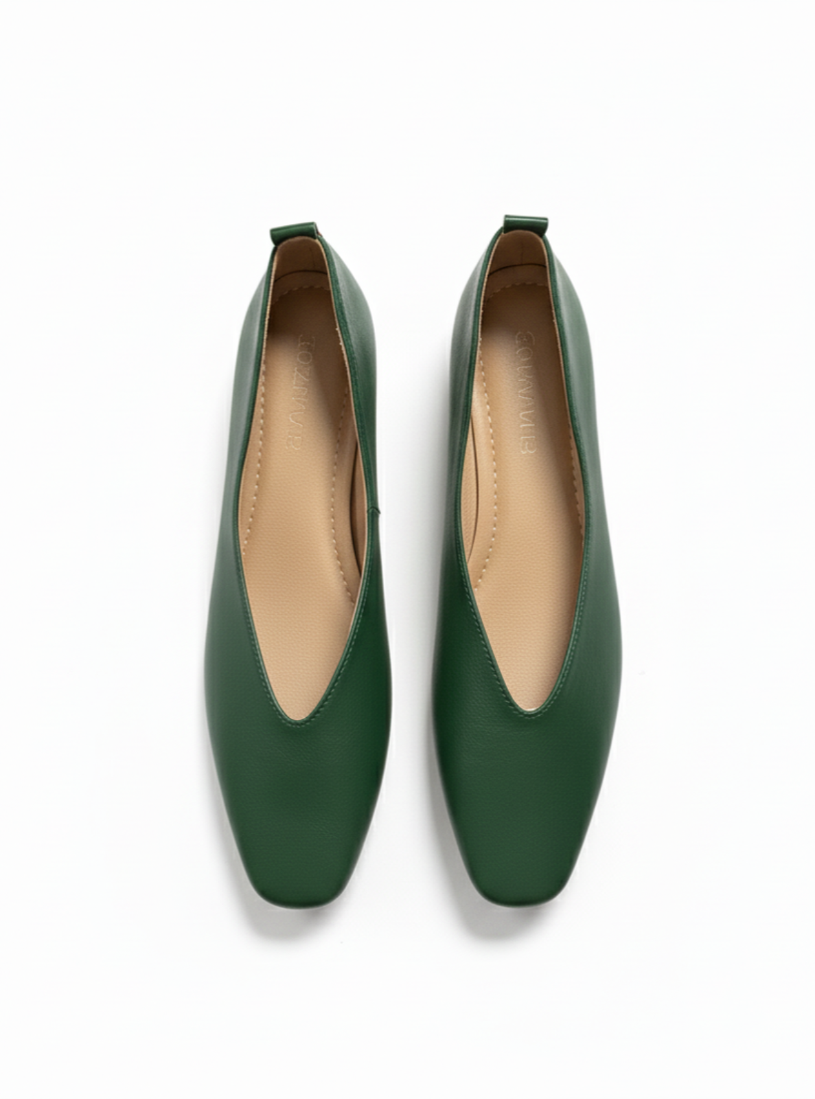 Pair of green flat shoes on a white background