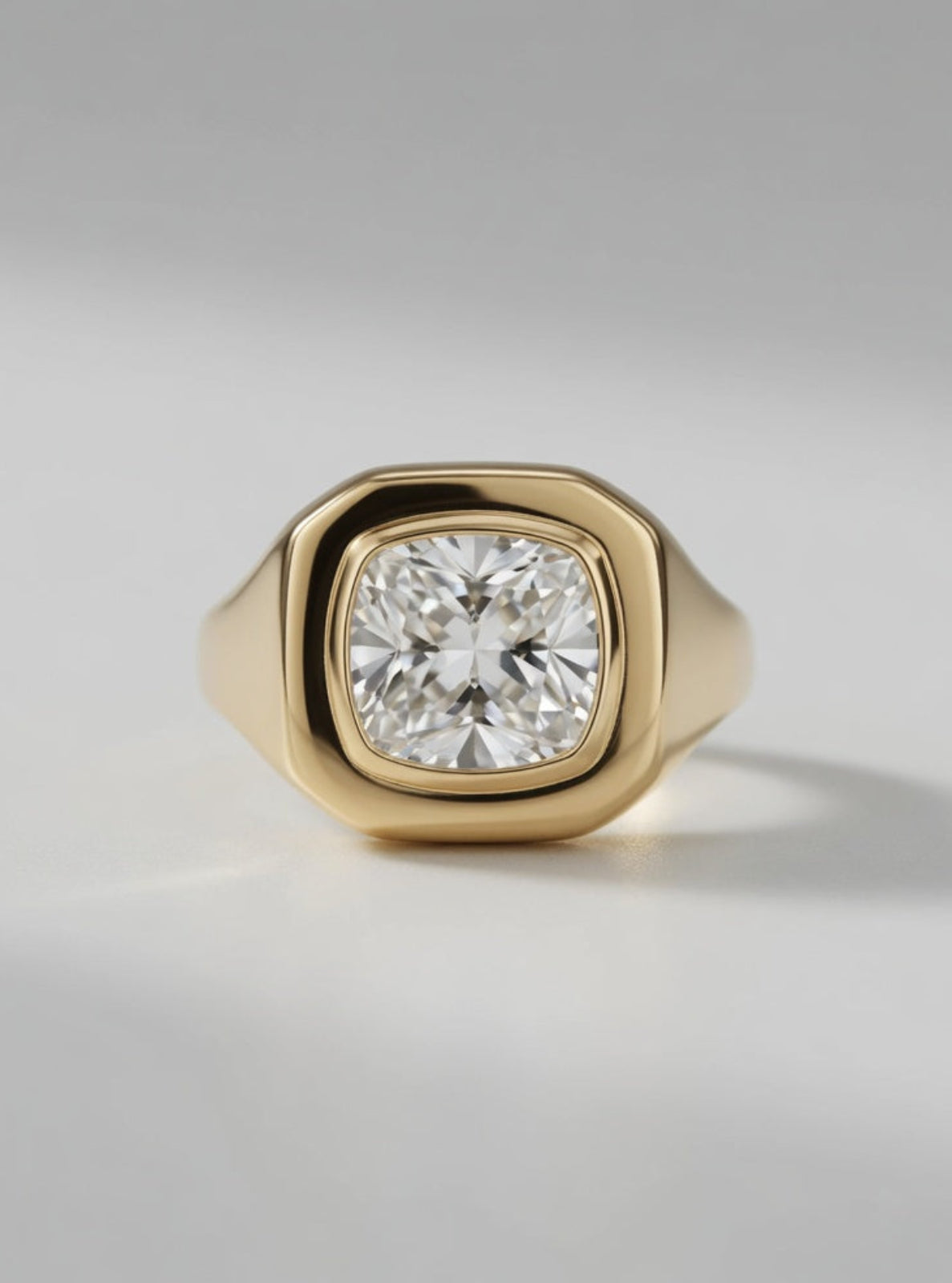 Gold ring with a diamond on a gray background