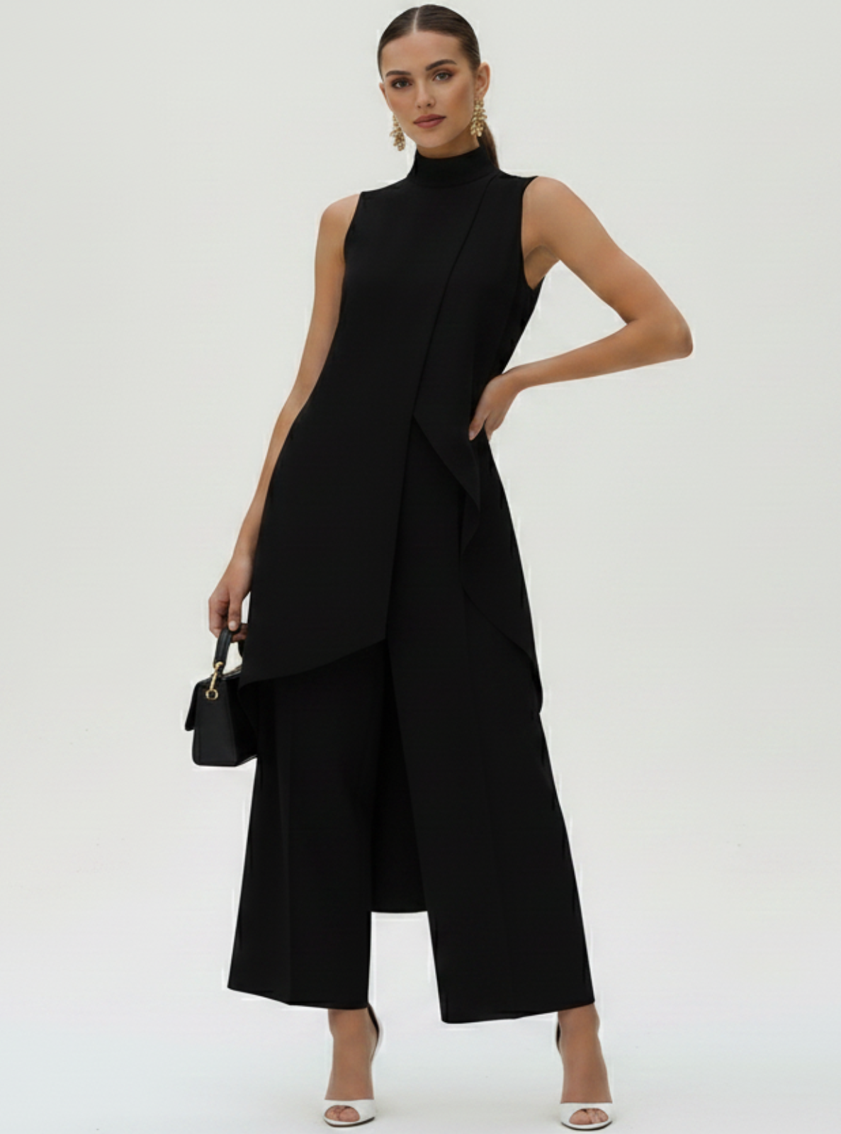 Woman wearing a black sleeveless dress with a white background
