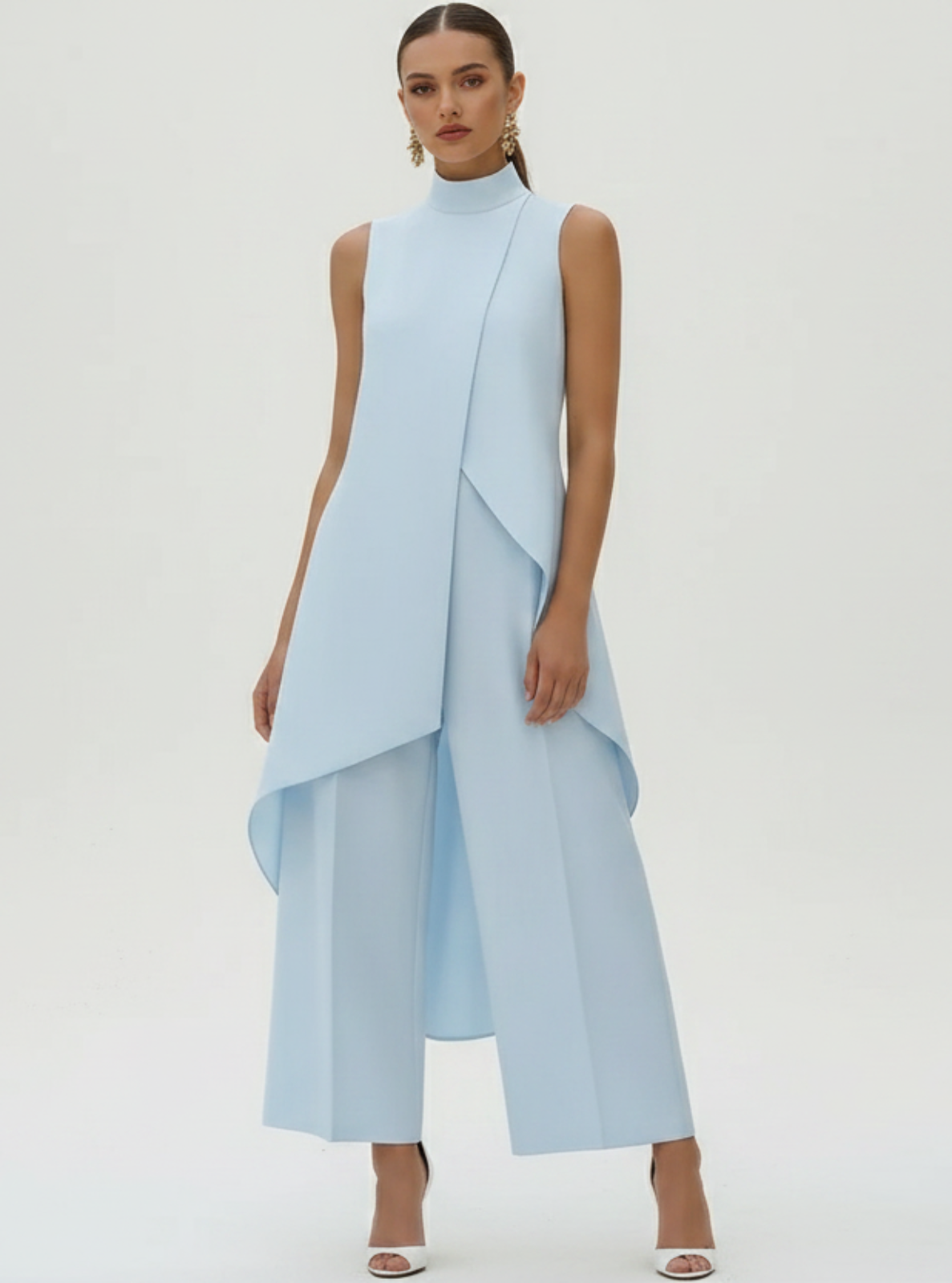 Woman wearing a light blue dress with a white background