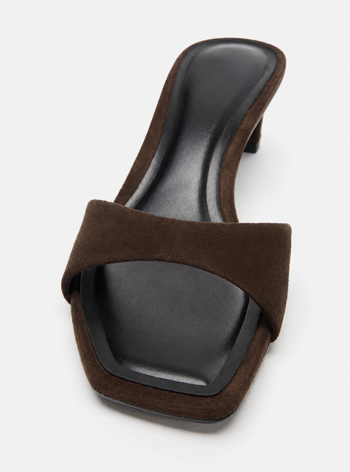 A single dark brown suede slide sandal with a square toe and a low block heel, shown from a top-down angle on a light gray background.